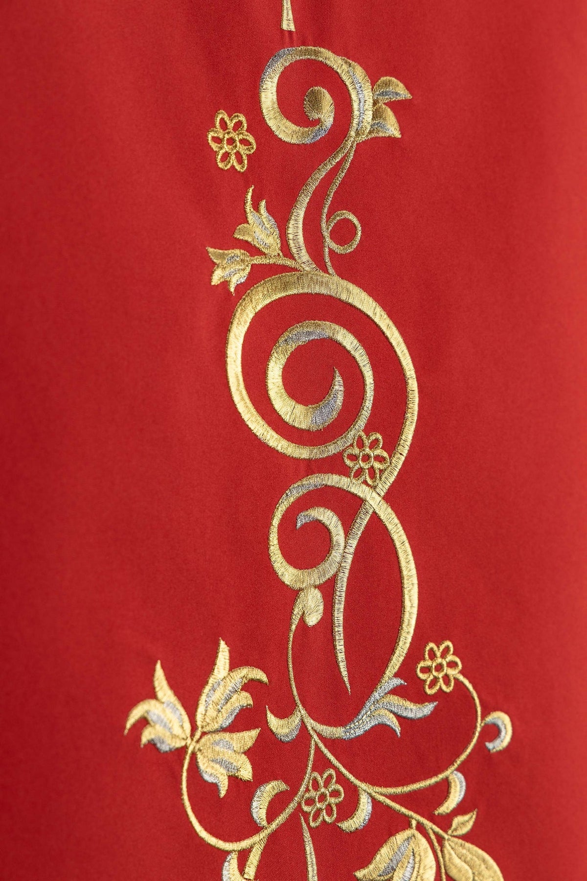 Church lectern cover close-up showing gold botanical ornament embroidery on red fabric