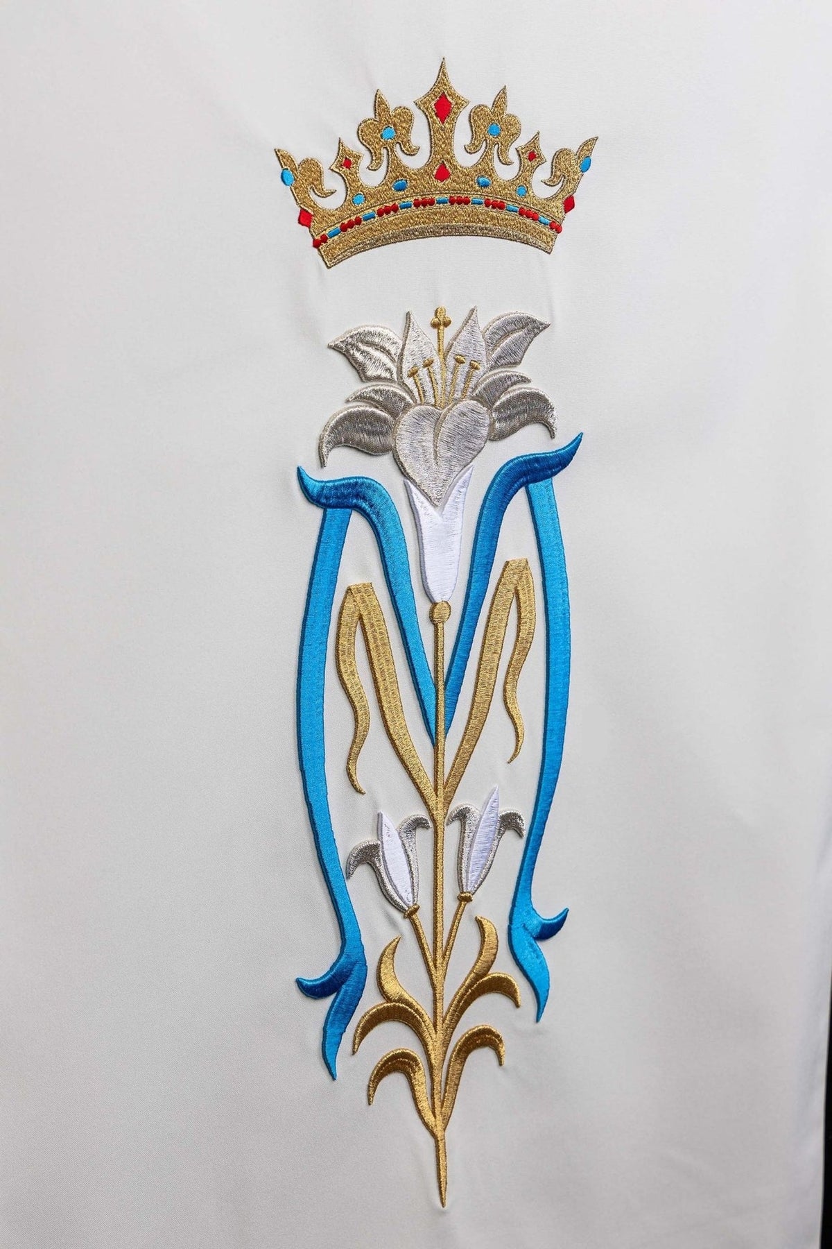 Church lectern cover close-up showing the full lily and crown embroidery