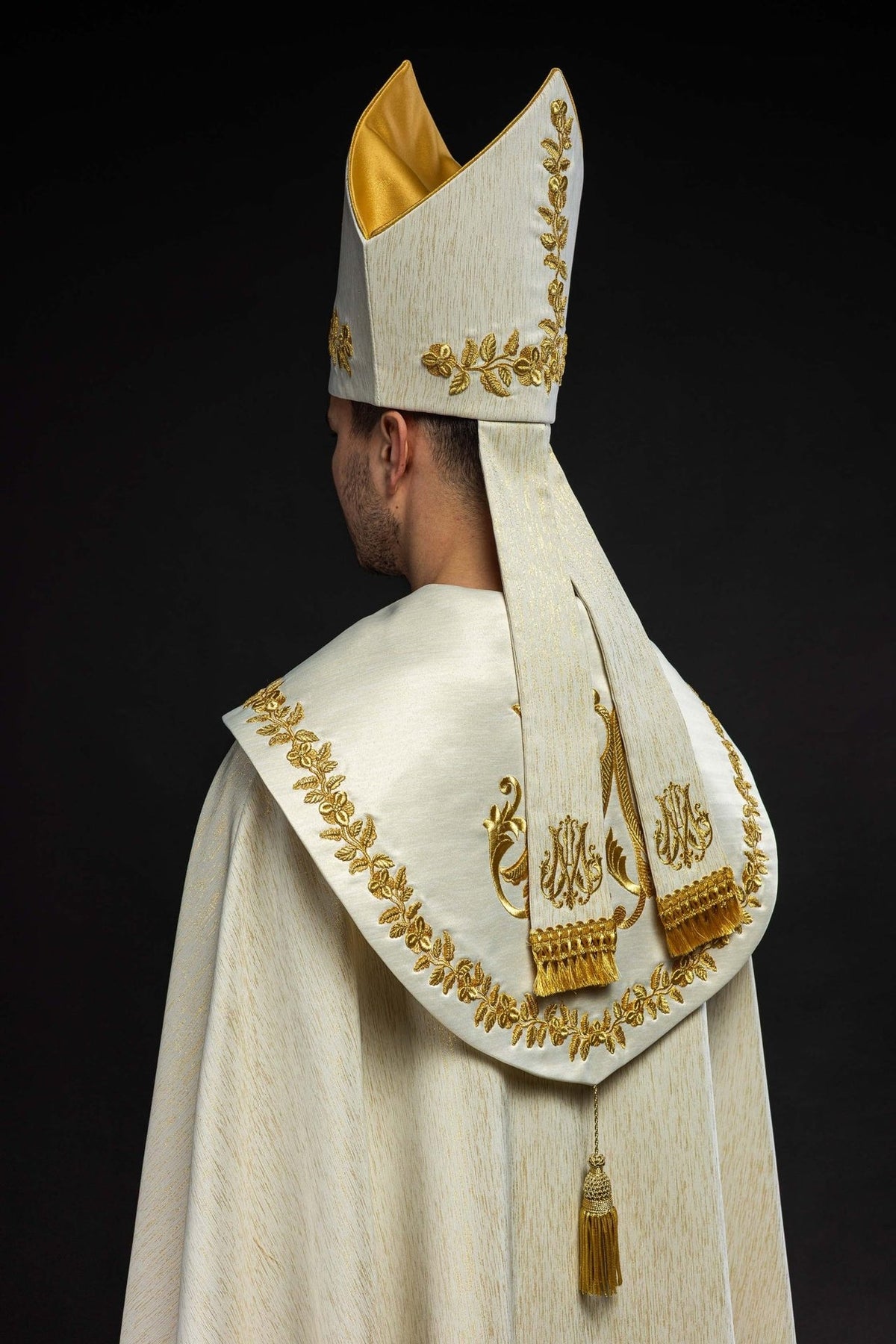 Ecru miter, back three-quarter view with gold floral embroidery and fabric bands