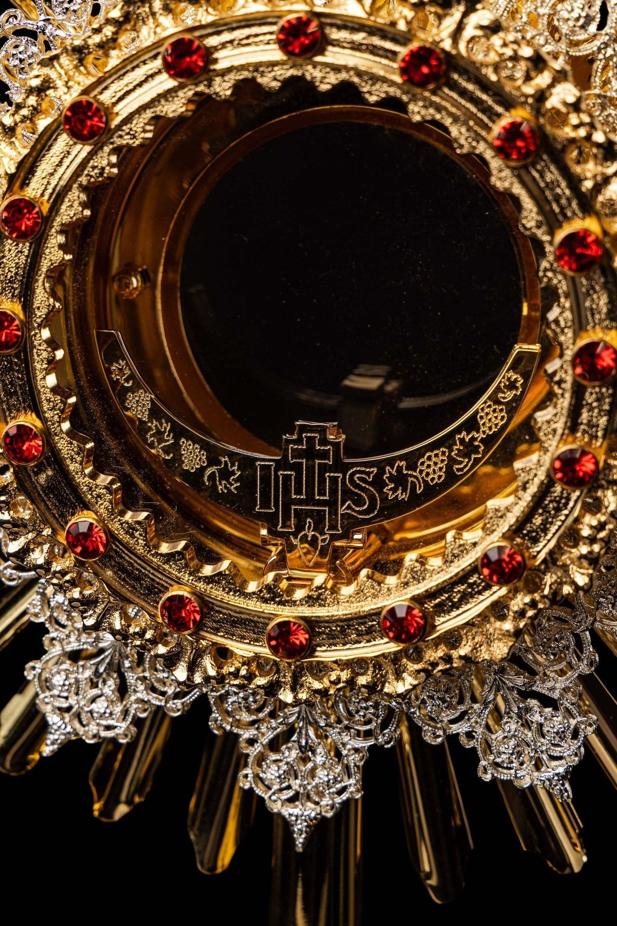 Monstrance close-up of ruby-studded rim and engraved IHS design