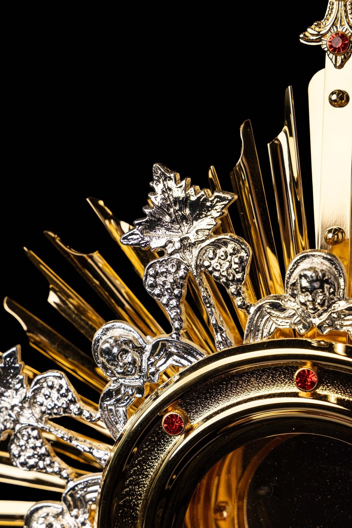 Monstrance upper detail with ornate cross and four red stones