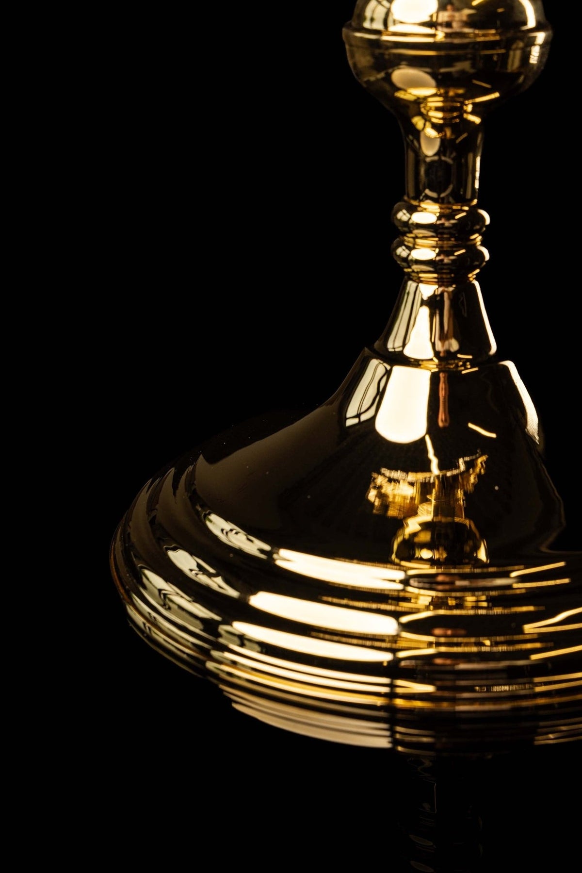 Monstrance close-up of polished gold stem and tiered circular base