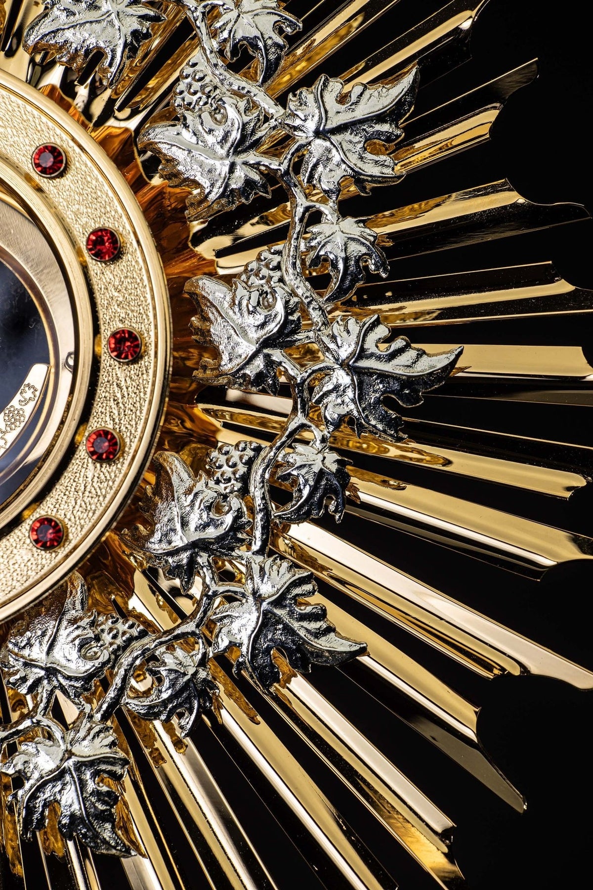 Monstrance angled close-up of the ruby-set host holder and silver vine ornamentation