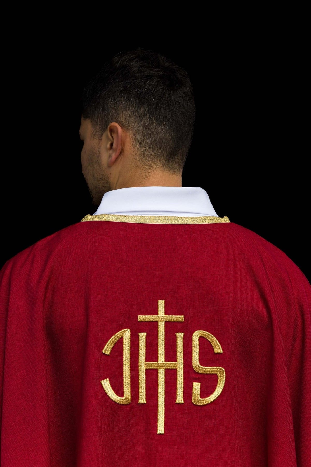 Red chasuble close-up of gold IHS embroidery