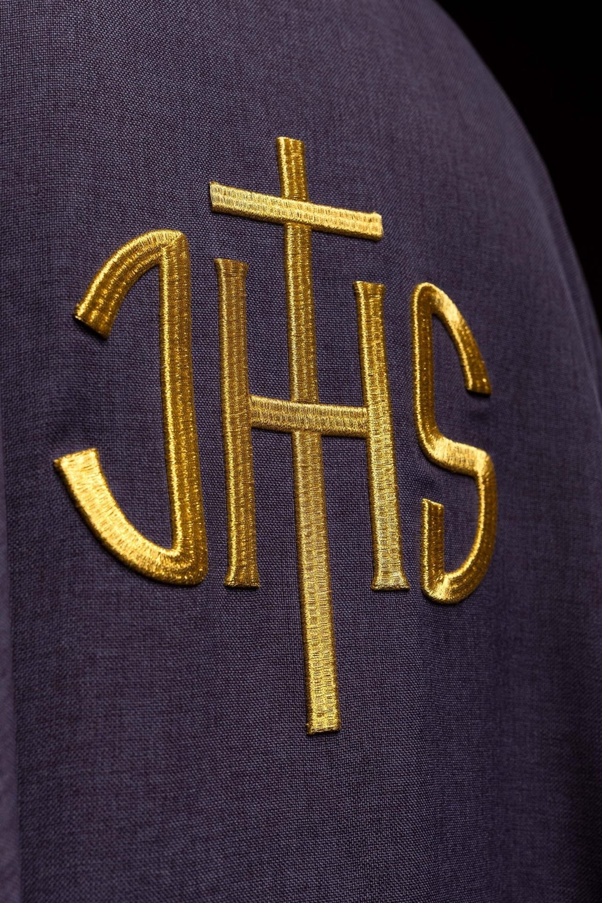 Purple chasuble close-up of gold IHS embroidery