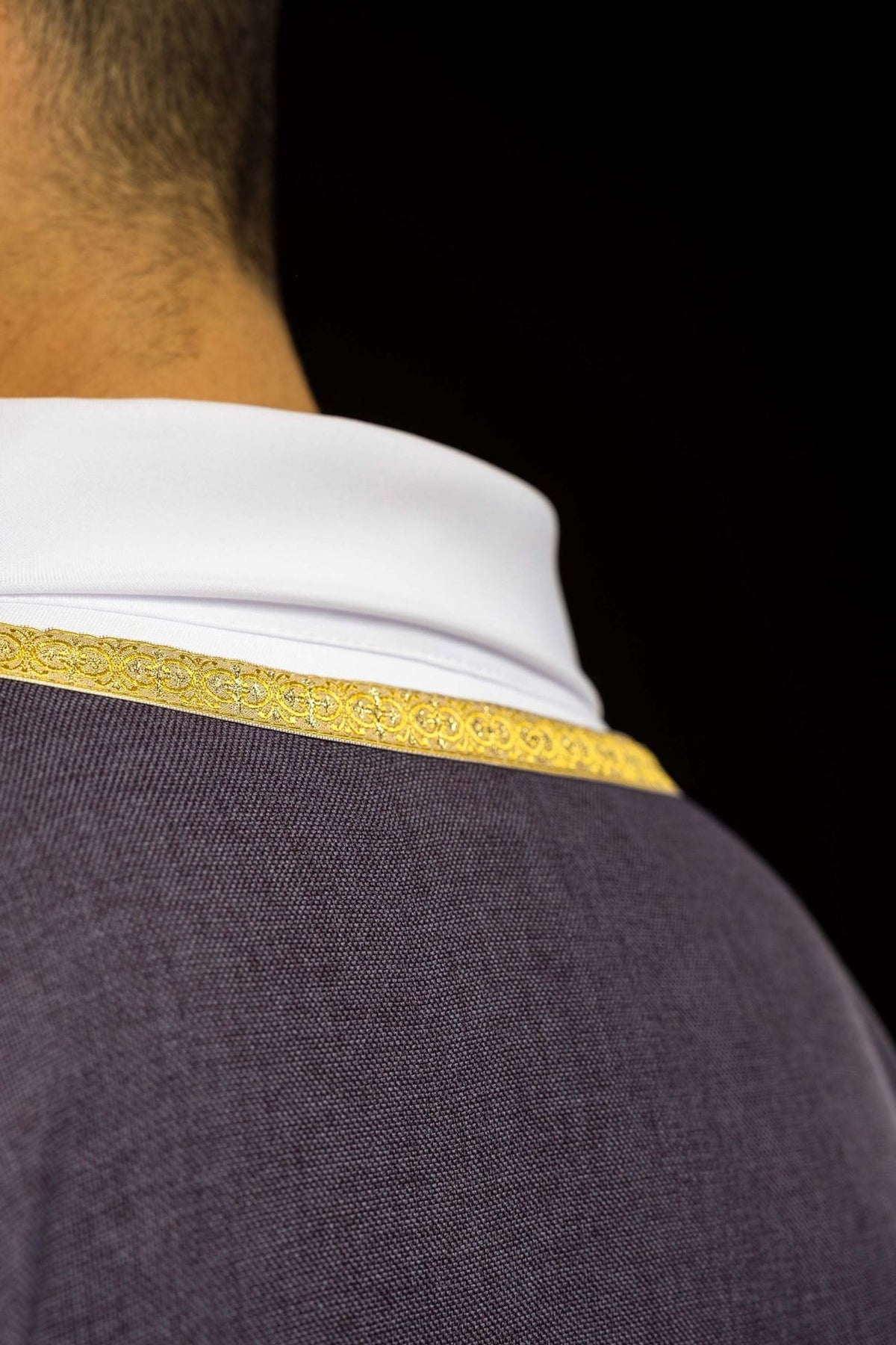 Purple chasuble close-up of white satin collar and gold trim