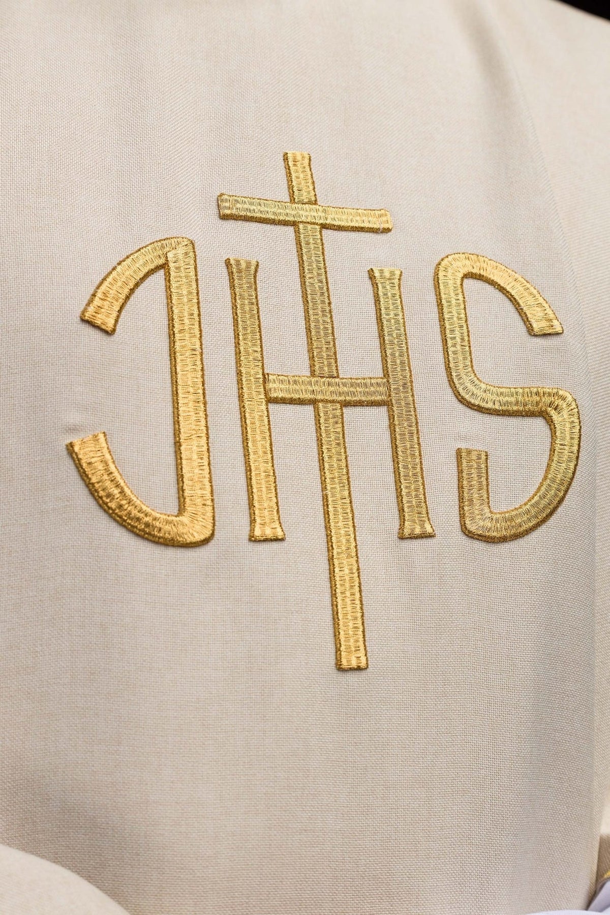 Ecru chasuble close-up of gold IHS embroidery