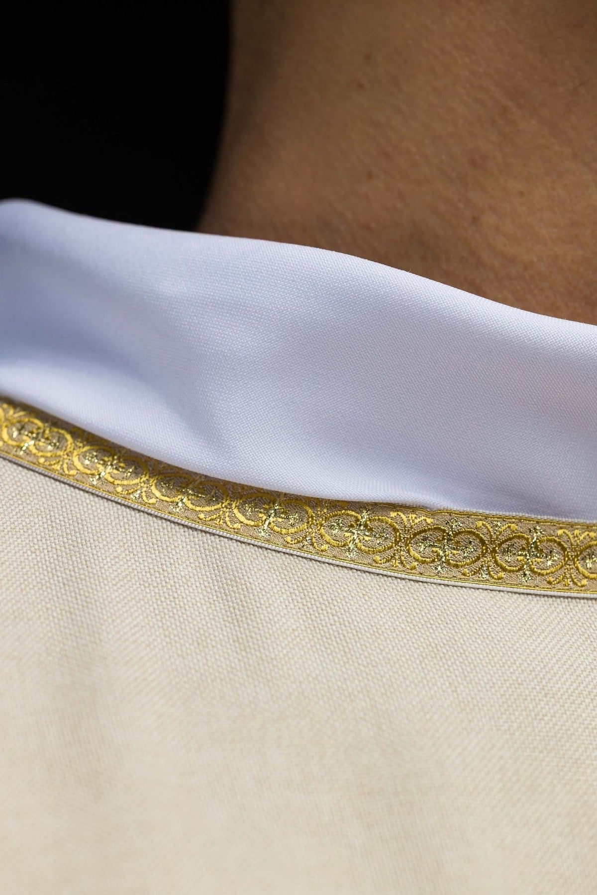 Ecru chasuble close-up of white collar and gold trim