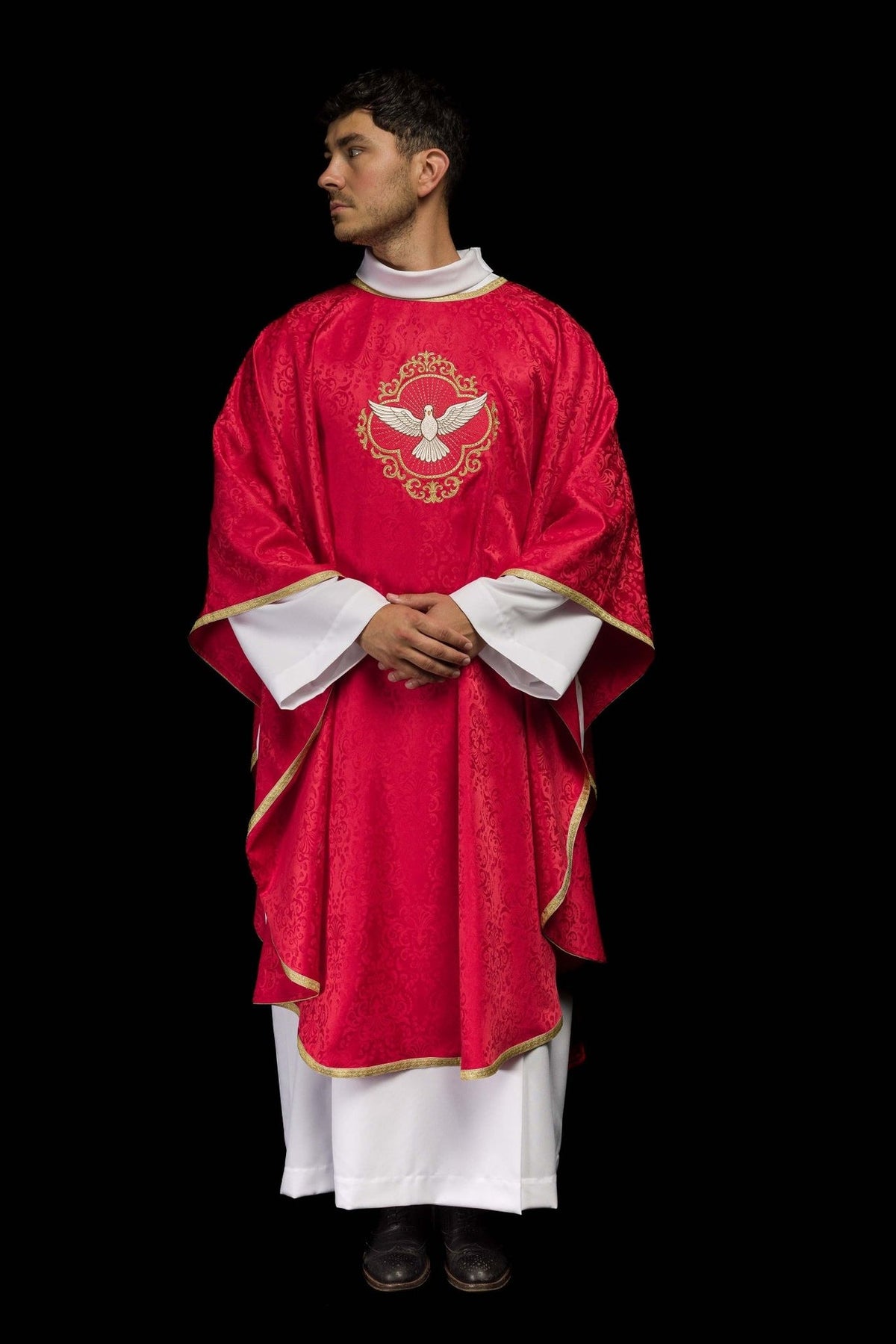 Red chasuble worn full-length front view with embroidered Holy Spirit and gold trim