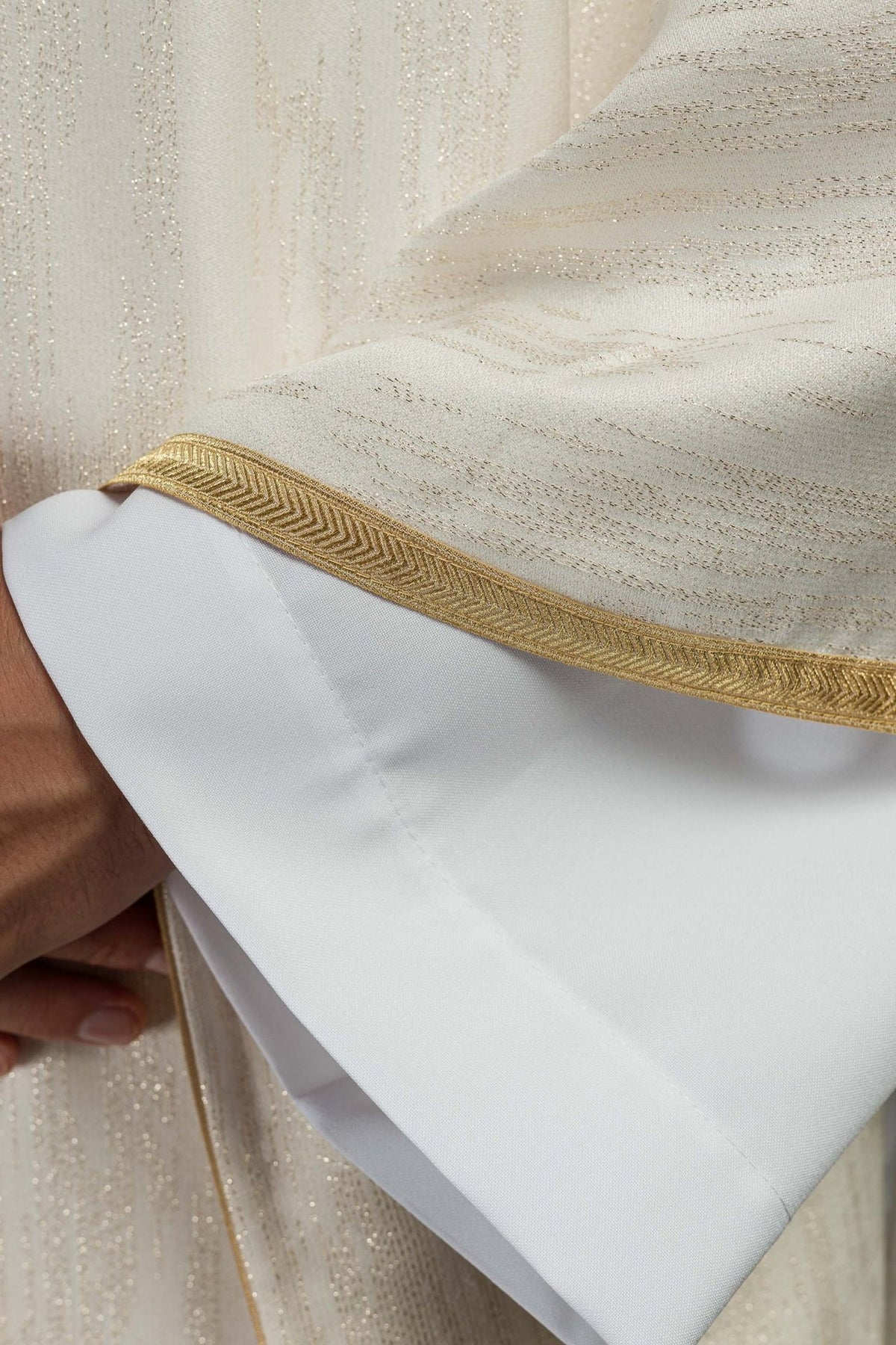 Ecru Marian motif chasuble, close-up of gold trim and sleeve