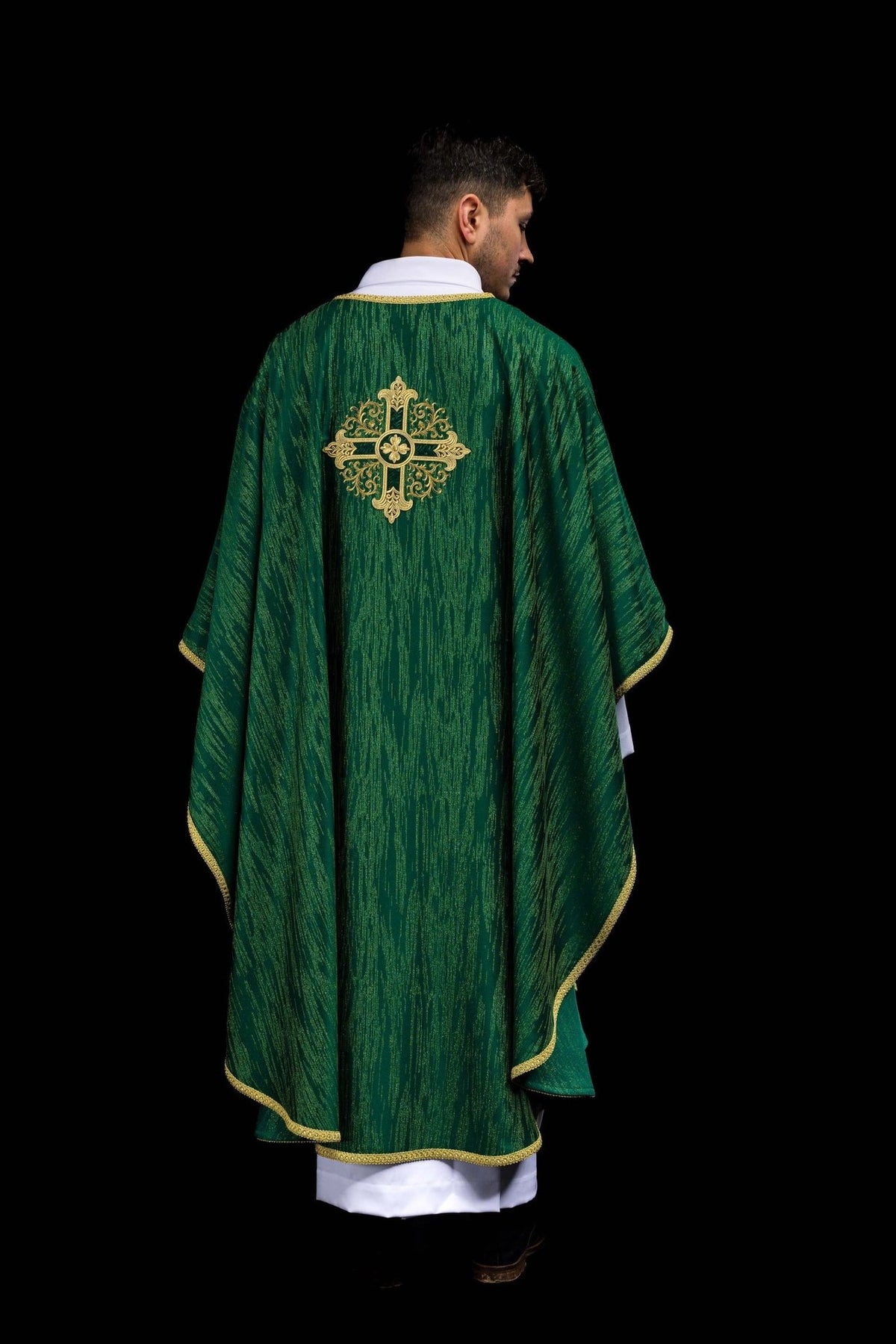 Green chasuble back worn view with gold embroidered cross