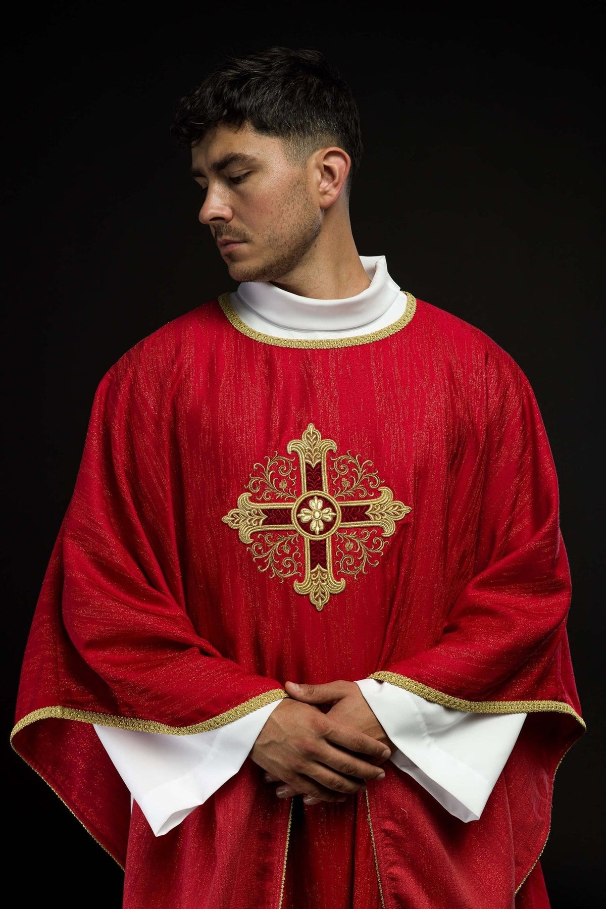 Red chasuble front close-up with embroidered gold cross