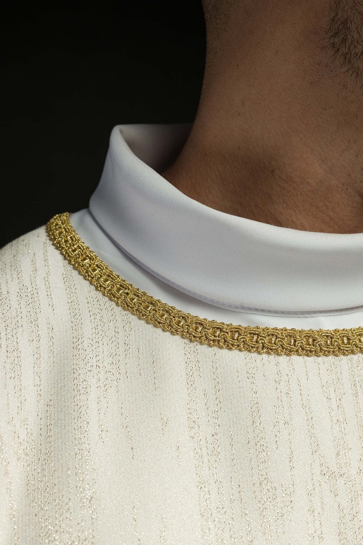Ecru chasuble close-up of white collar and gold neckline trim