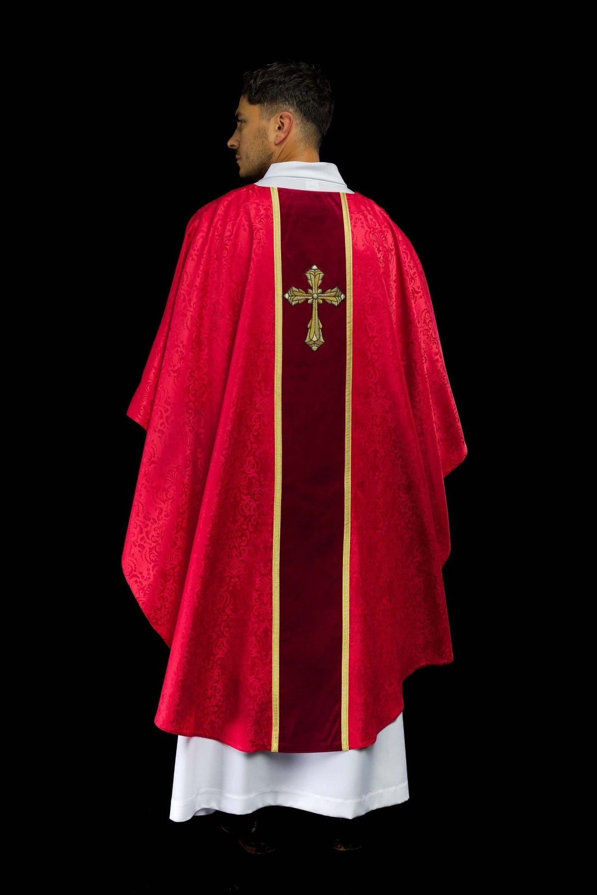 Red chasuble back view showing jacquard fabric and central orphrey
