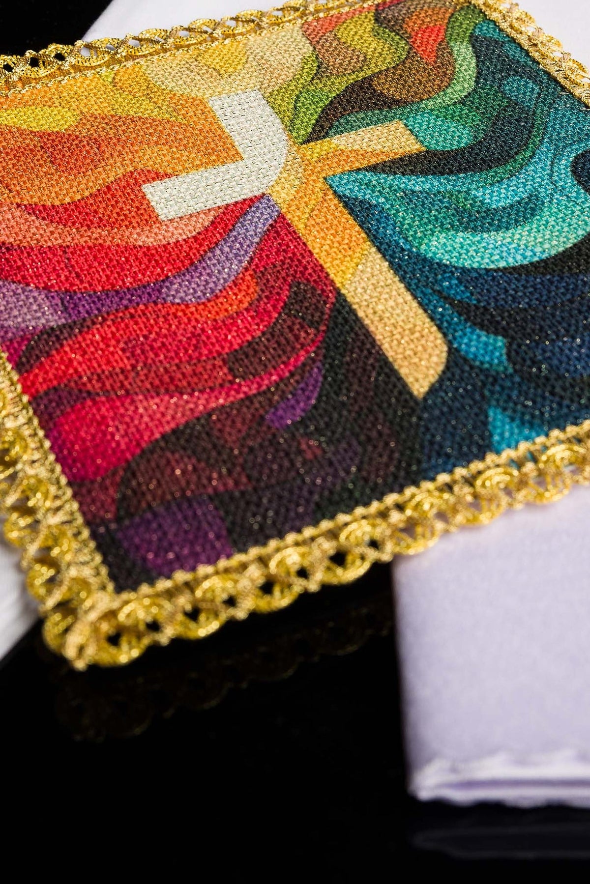 Altar linen set close-up of colorful cross panel with gold decorative border
