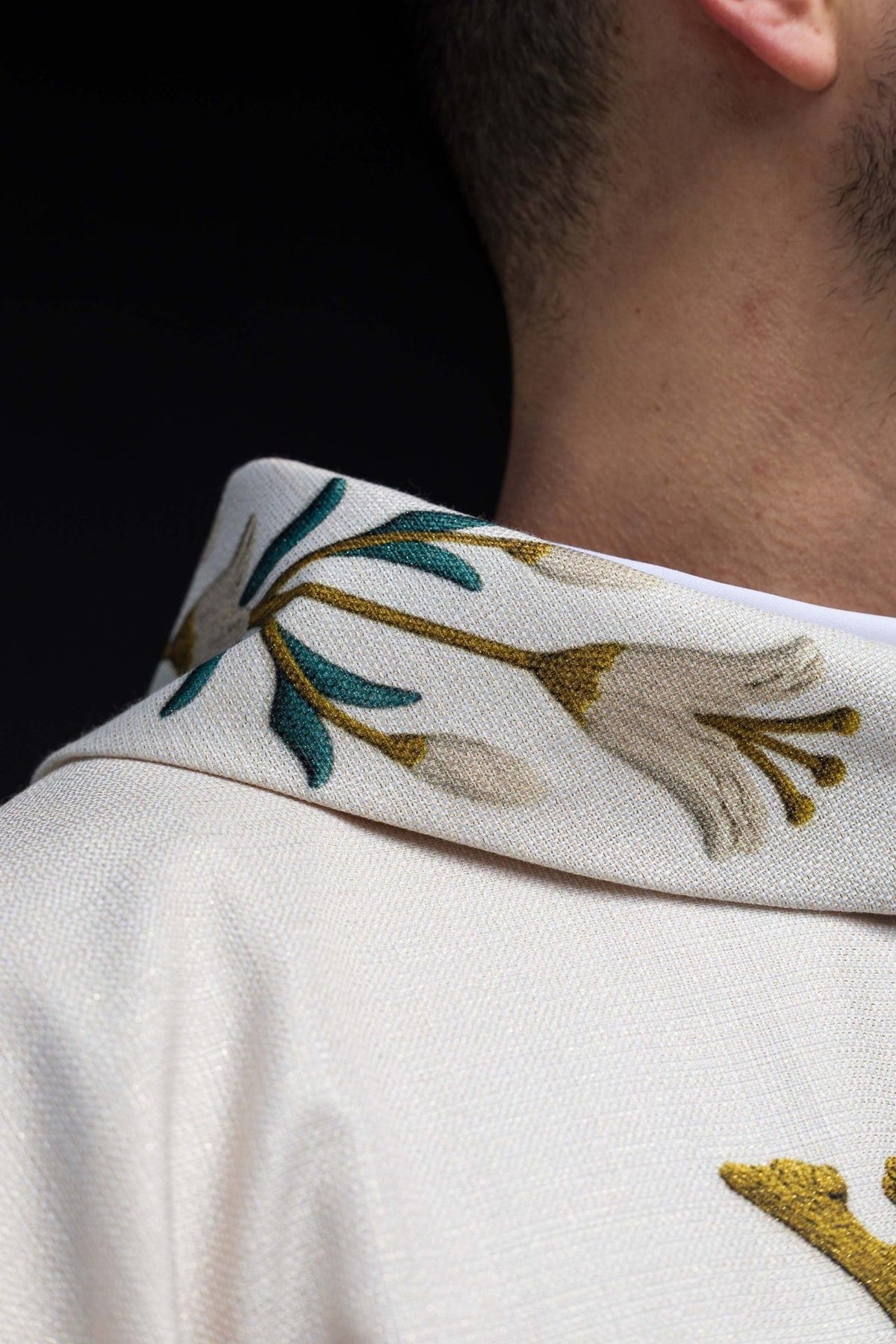 Marian chasuble collar close-up with printed lily pattern and Marian monogram