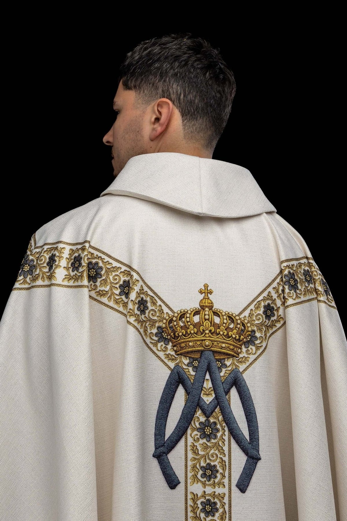 Marian chasuble back view with gold crown, light blue Marian symbol and floral orphrey