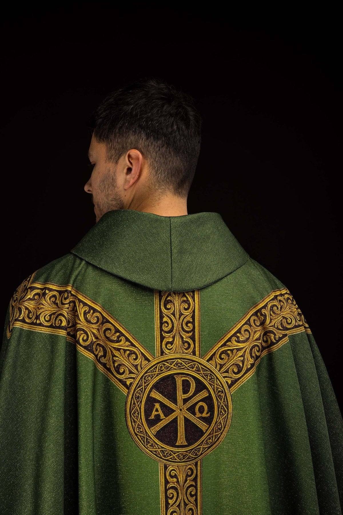 Green chasuble close-up of the gold Pax cross and upper orphrey