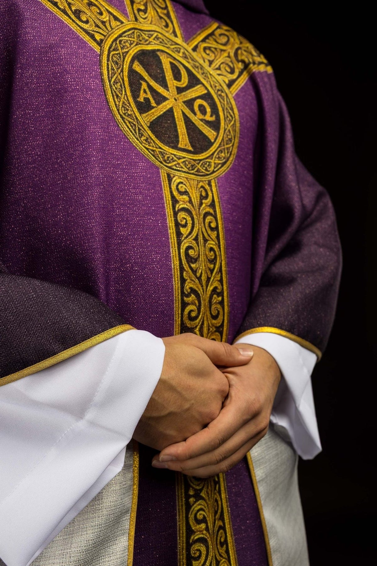 Purple Pax chasuble side close-up with gold emblem and vertical orphrey