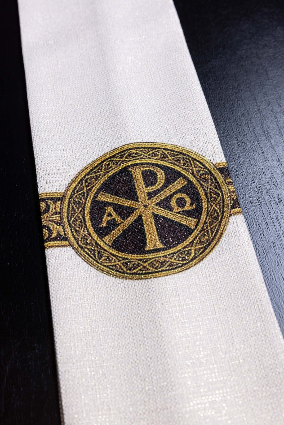 Ecru stole close-up showing printed Pax cross and gold orphrey