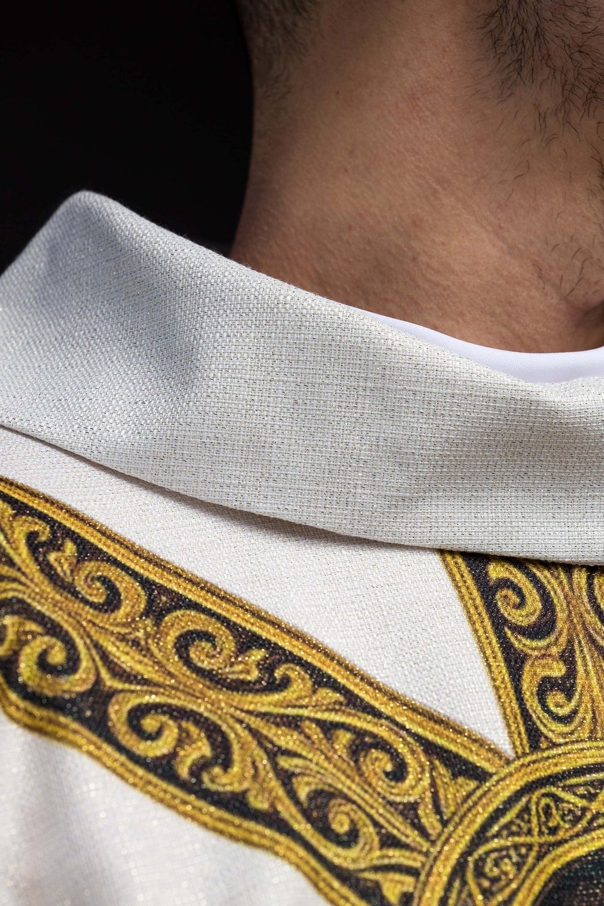 Ecru Catholic chasuble close-up showing cream collar and gold-trimmed orphrey