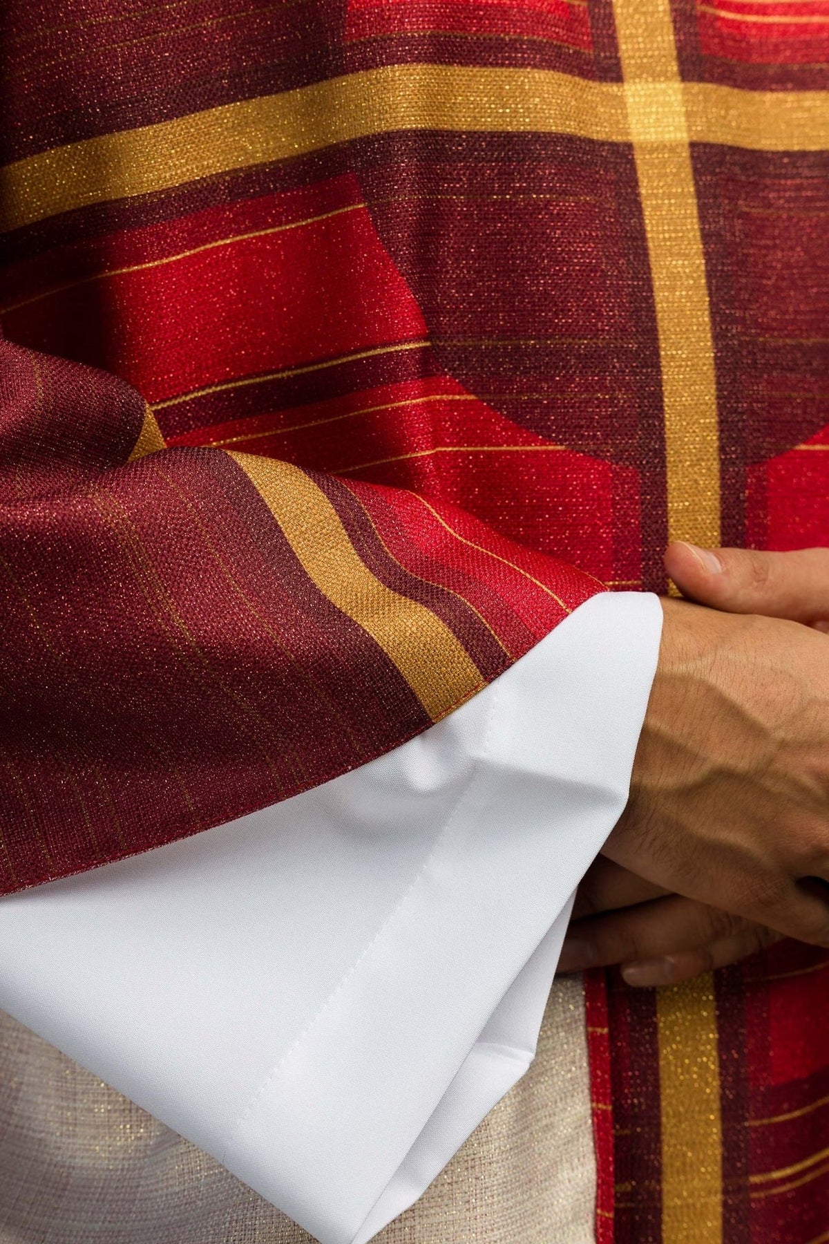Red chasuble cross and striped sleeve detail