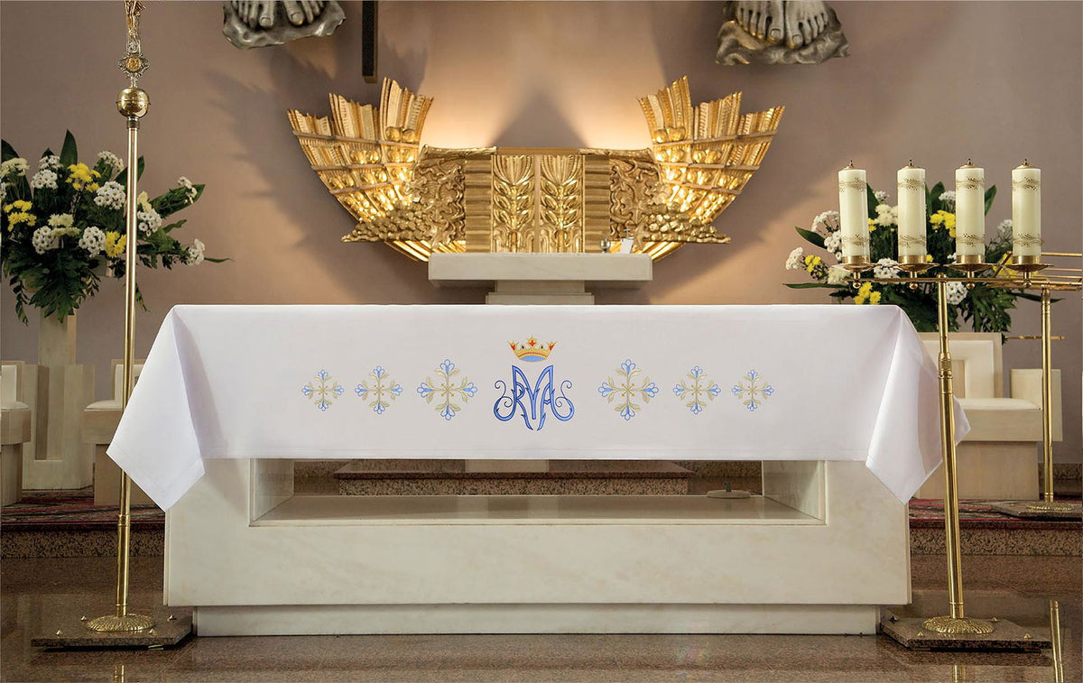 Altar cloth shown fully draped, with central blue Marian monogram and repeated embroidered motifs