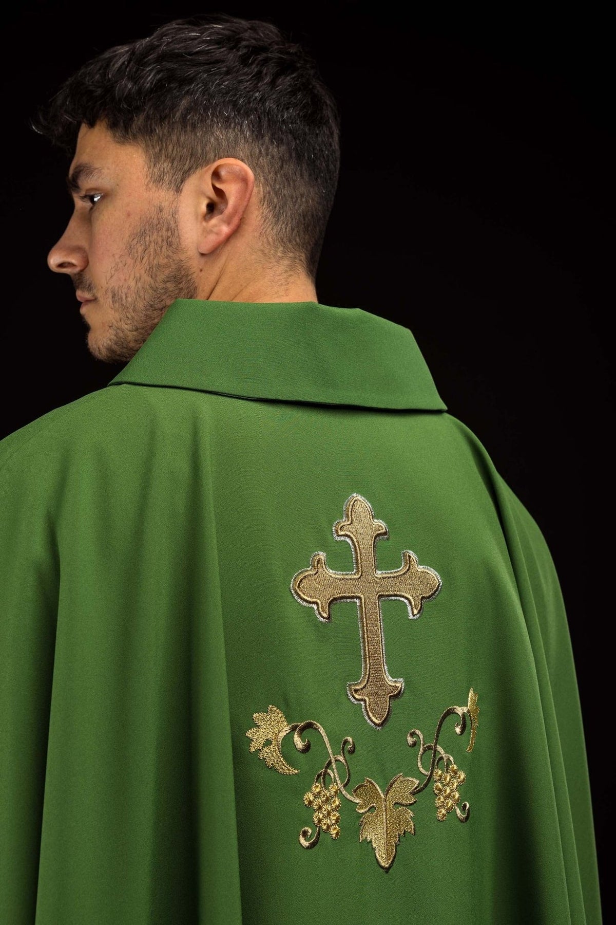 Green embroidered chasuble close-up showing wide collar and gold embroidery