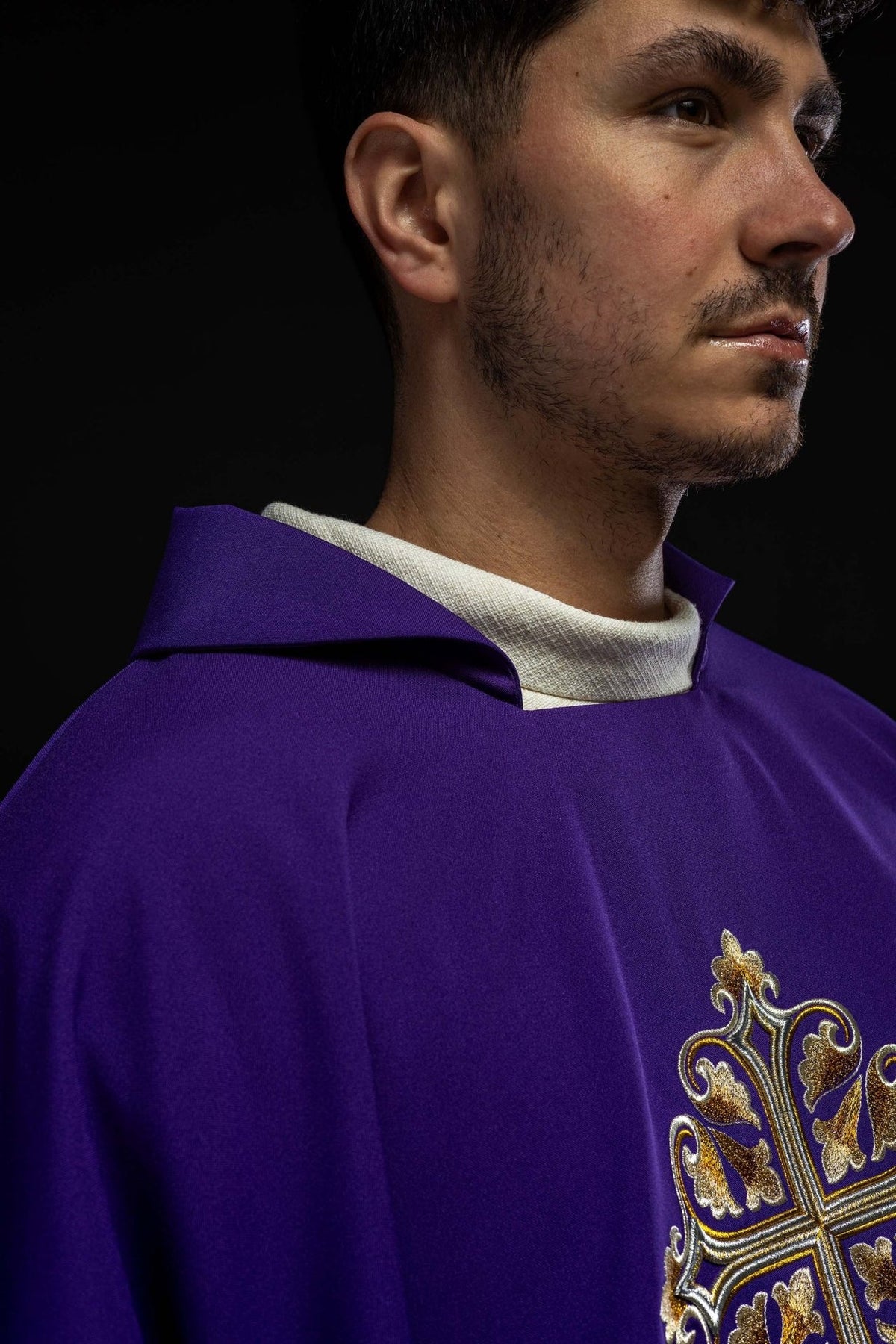 Purple chasuble side close-up showing wide square collar and embroidered cross