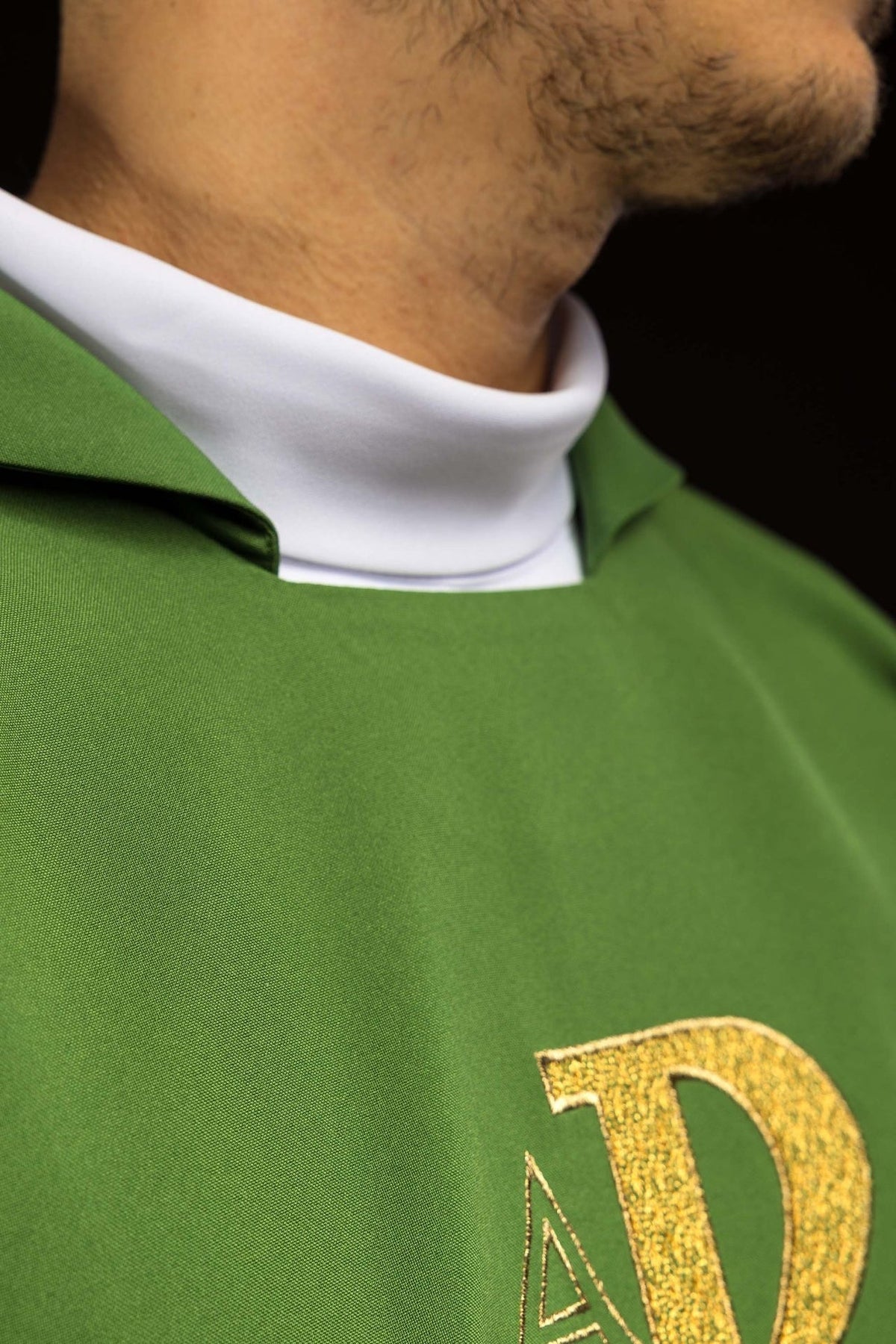 Green chasuble close-up showing wide collar and gold embroidery