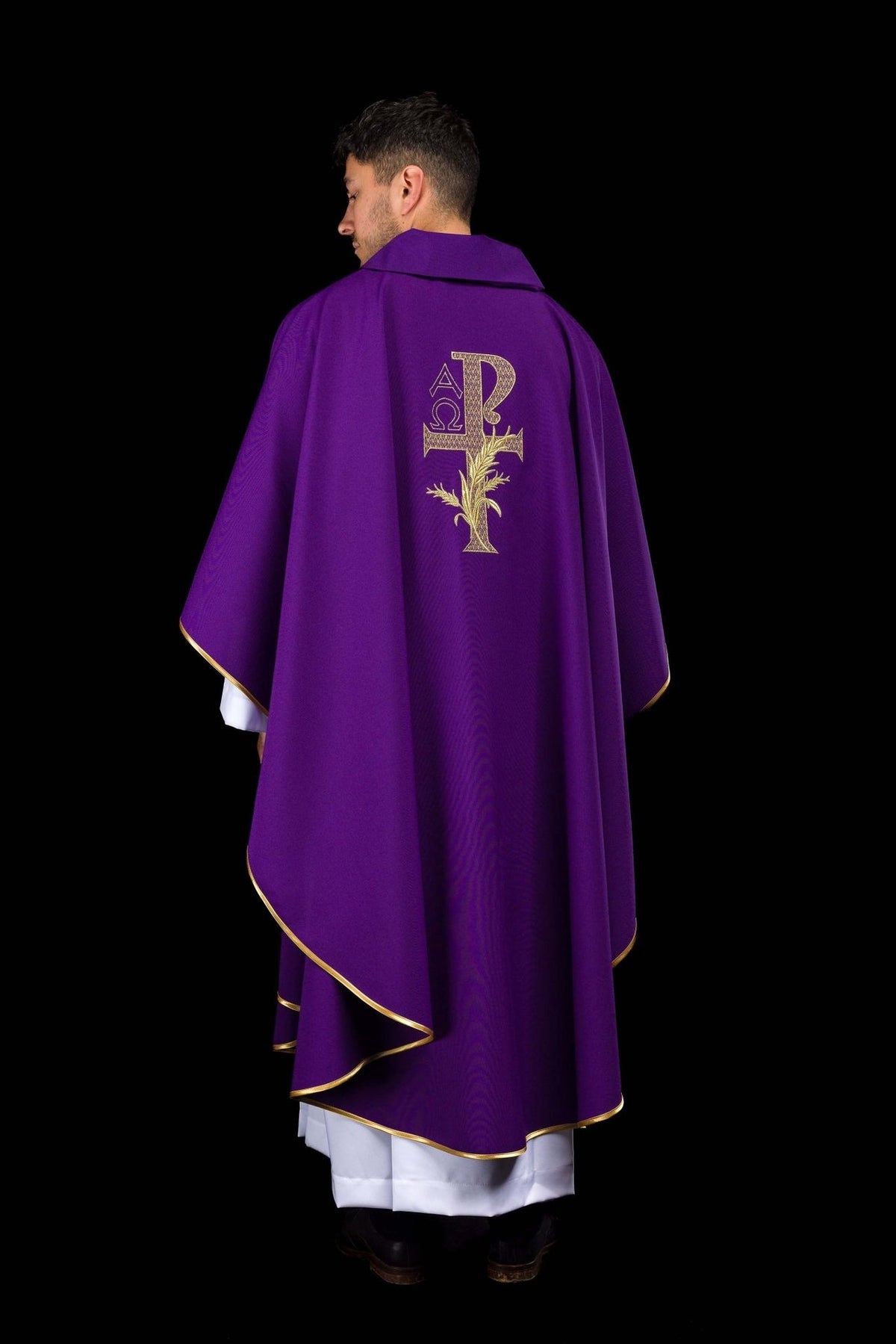 Purple chasuble back view with gold trim and Alpha Omega embroidery