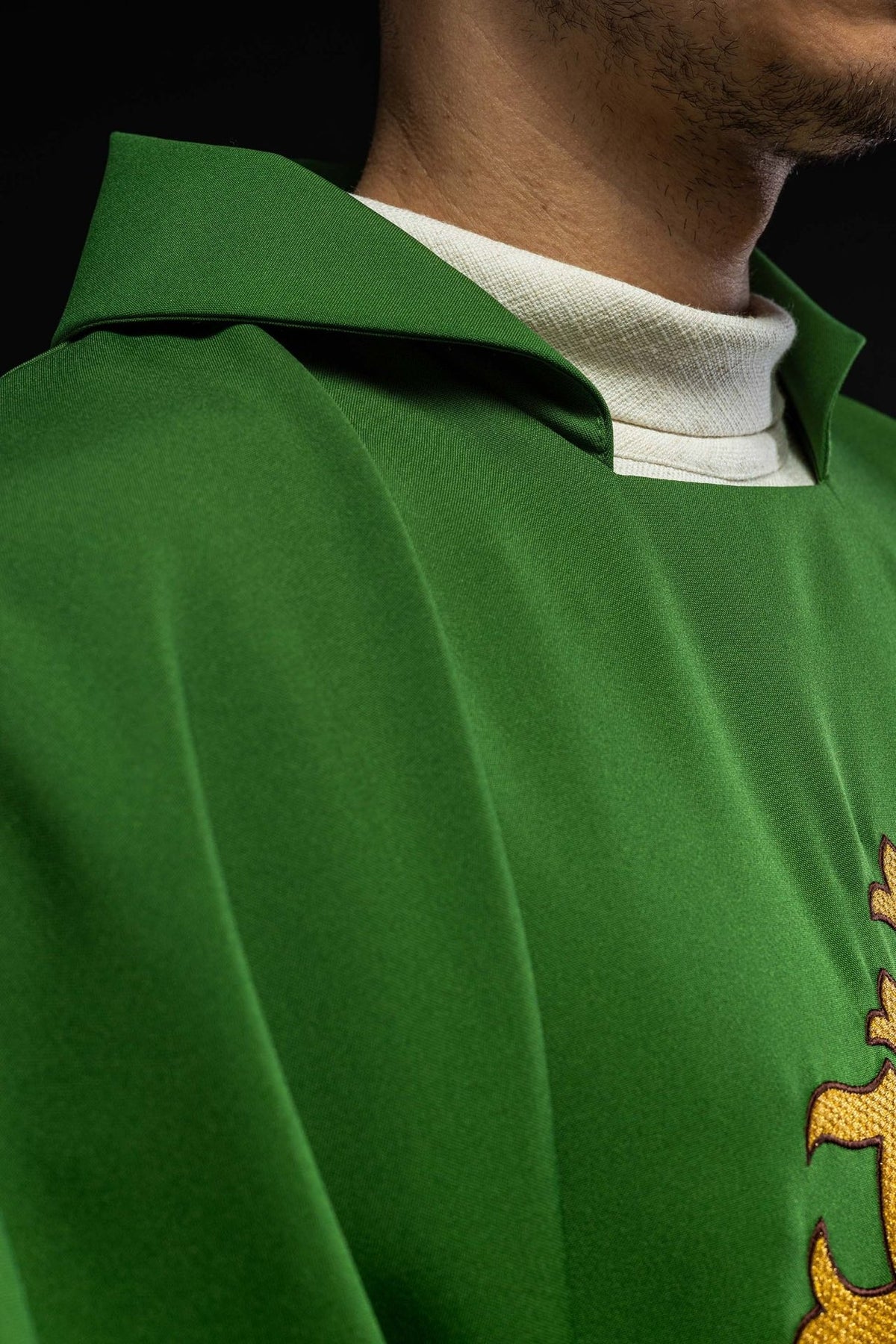 Green chasuble close-up showing the wide collar and green fabric
