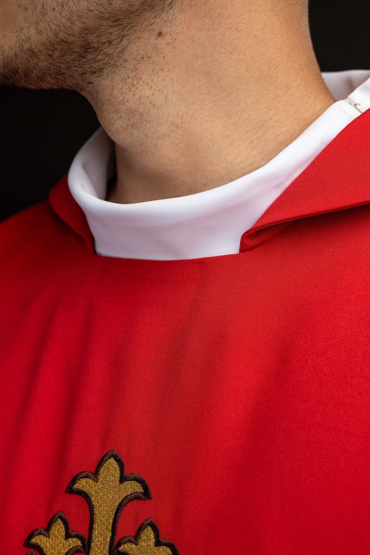 Red chasuble close-up showing the wide collar and red fabric