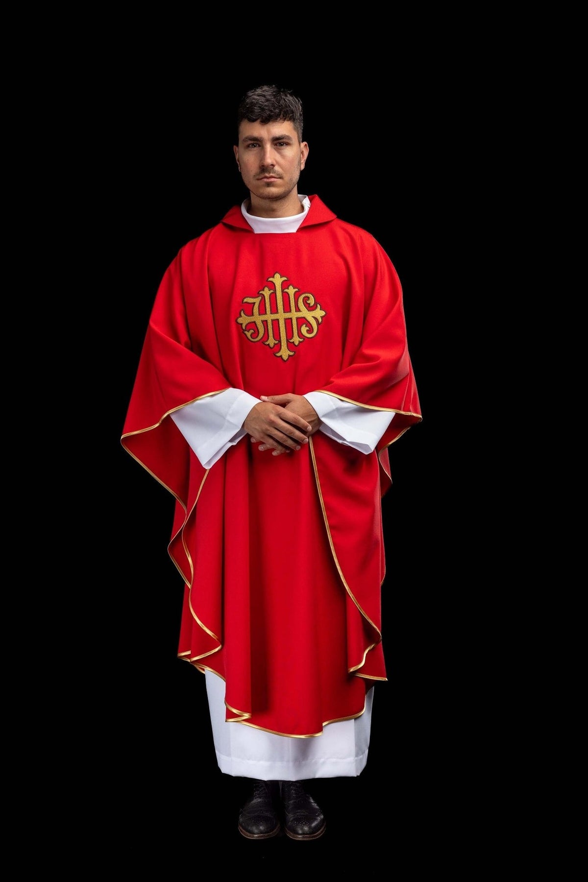 Red chasuble front view showing wide collar, gold trim and JHS embroidery