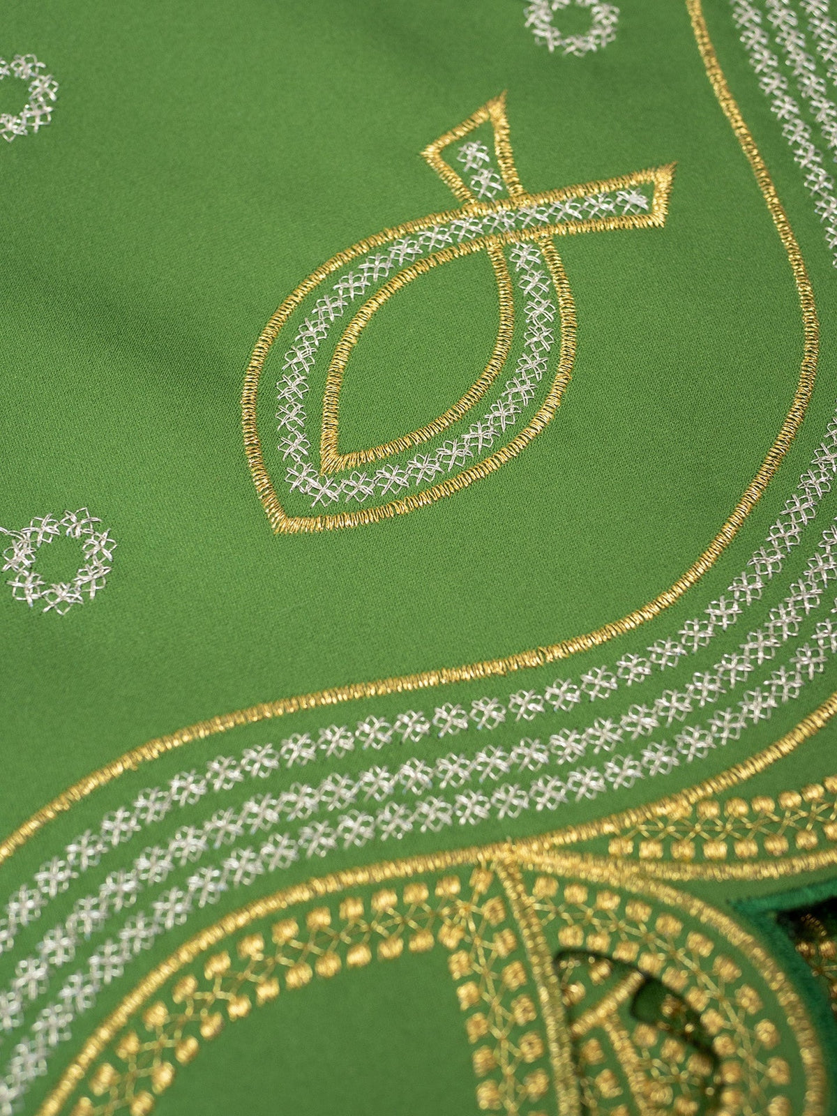 Green altar lace close-up showing PAX embroidery and gold-and-white border details