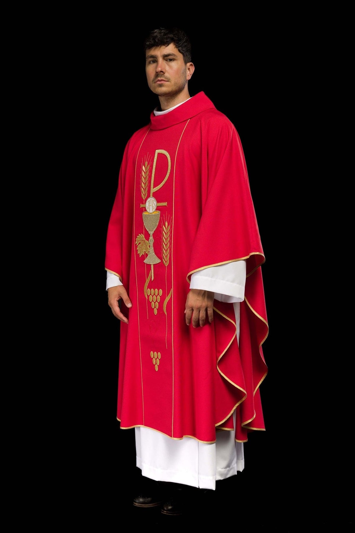 Red chasuble, angled front view showing gold trim and chalice IHS embroidery