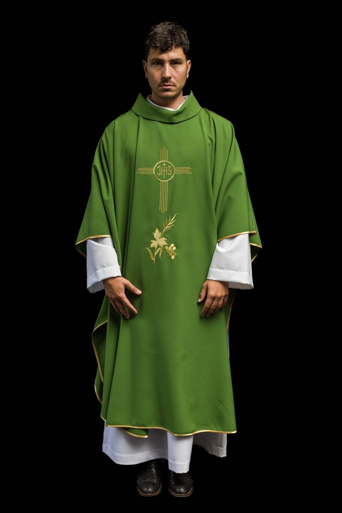 Green chasuble worn in full front view with gold IHS embroidery and trim