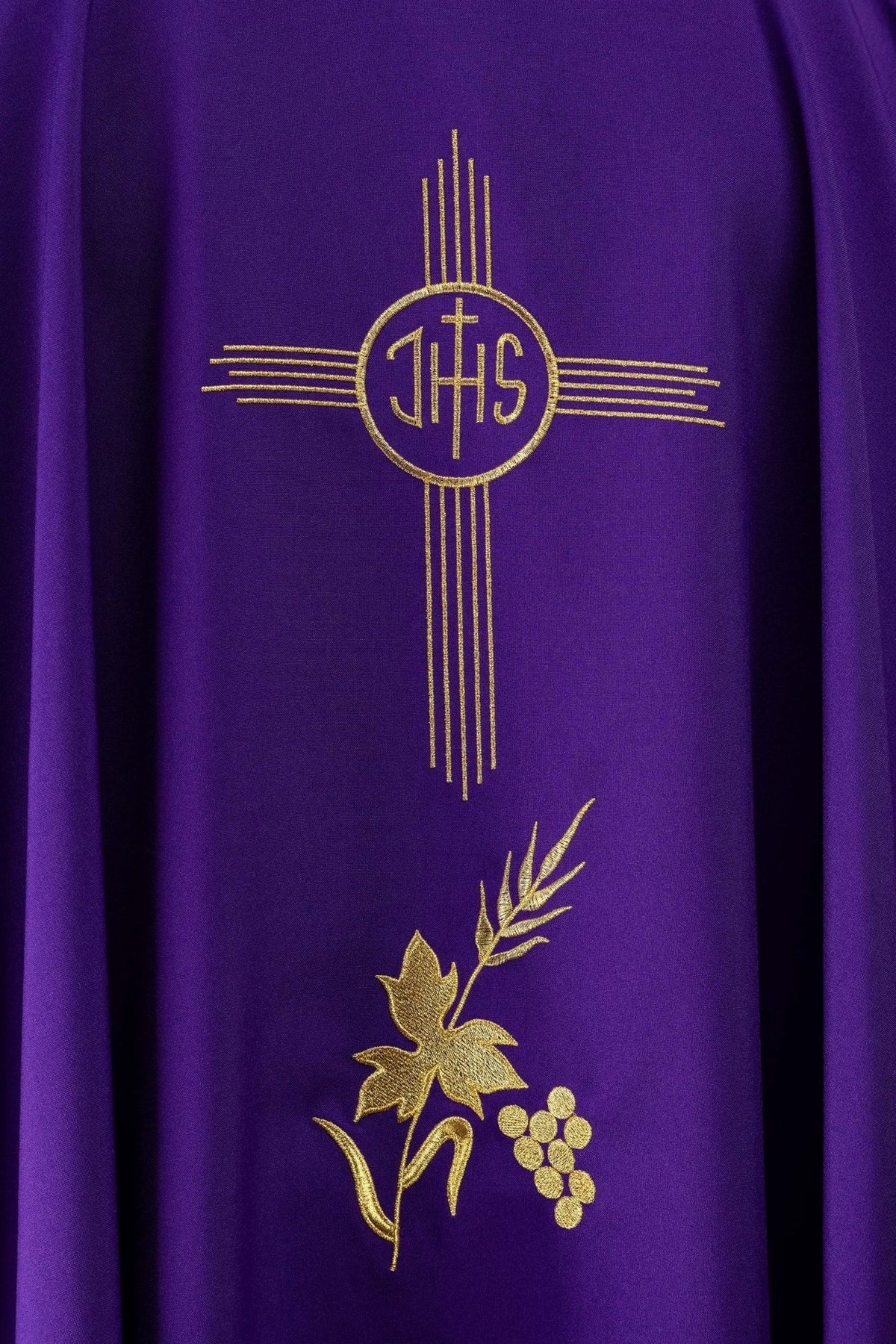 Purple chasuble close-up with gold IHS and floral embroidery