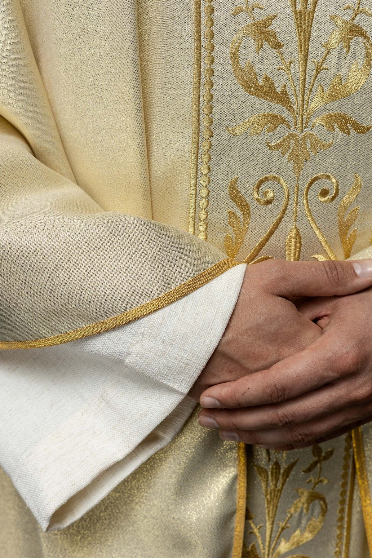 Liturgical chasuble, close-up of gold trim, orphrey and satin sleeve edge