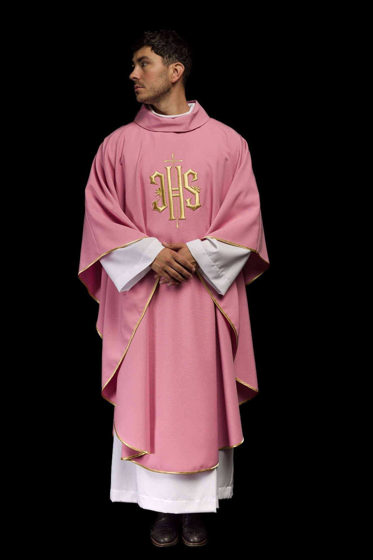 Rose chasuble rear three-quarter view with gold trim and IHS embroidery