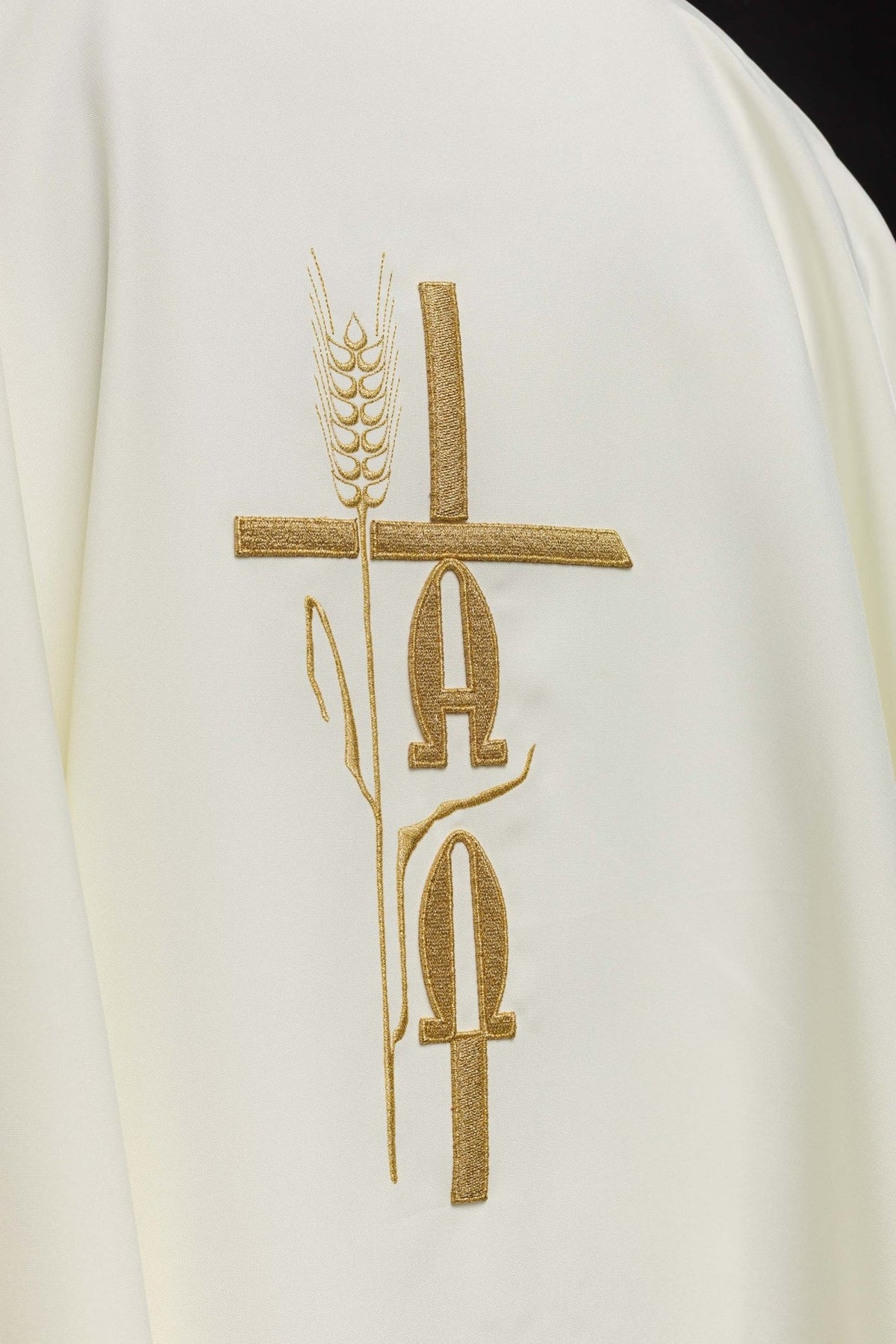 Ecru chasuble back close-up with gold Alpha, Omega and cross embroidery