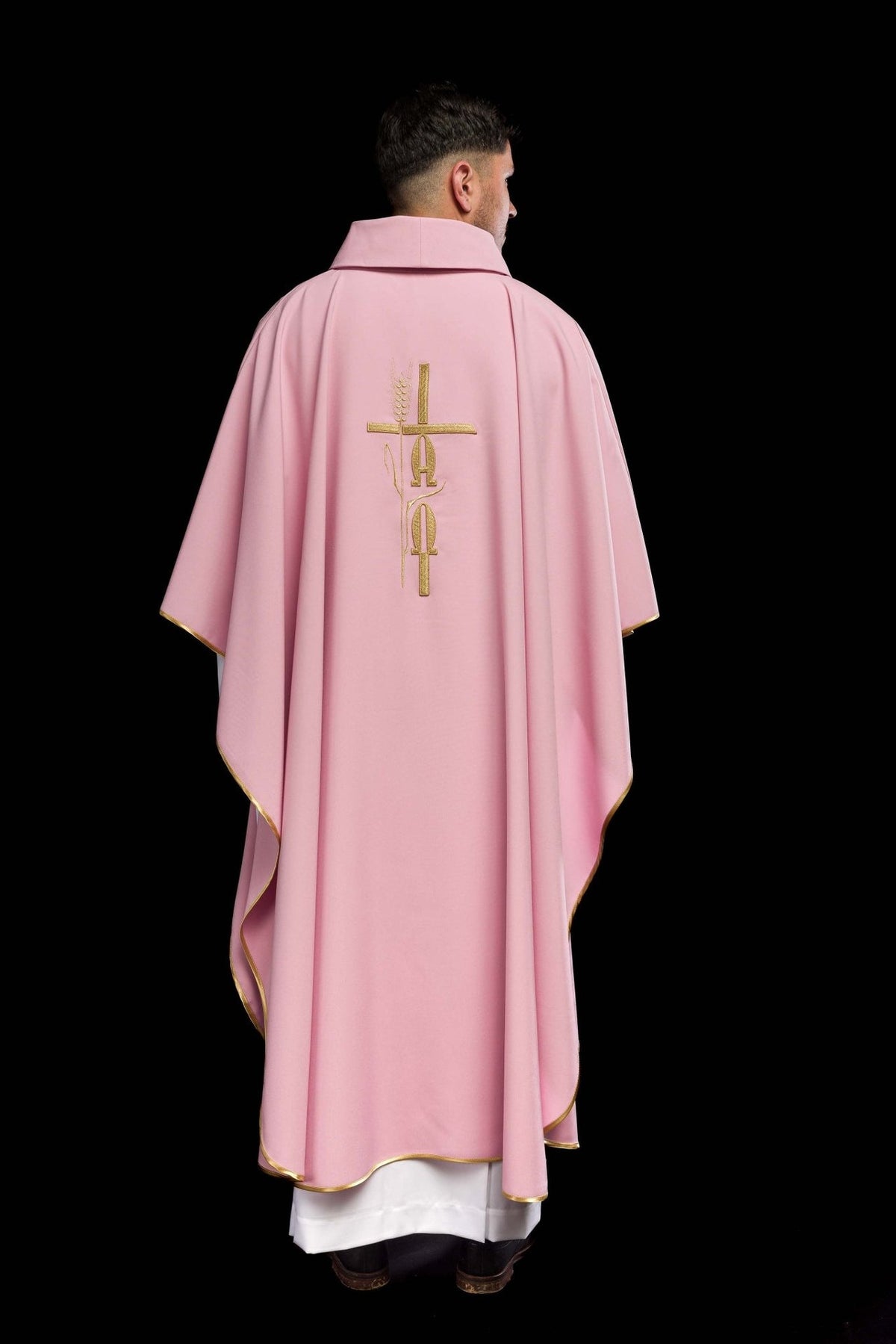 Chasuble back view showing pink fabric, gold embroidery and trim