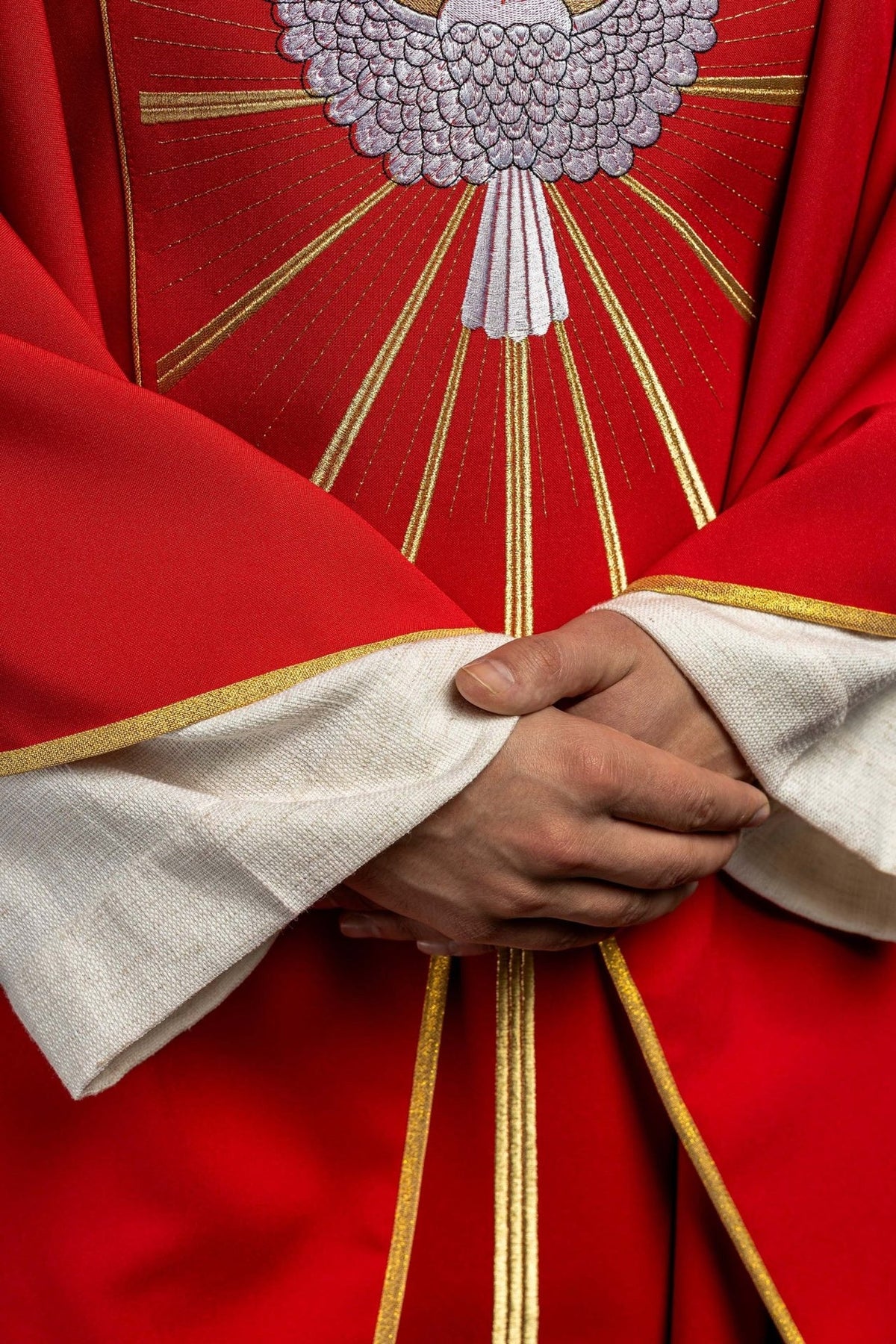 Red chasuble close-up of embroidered Holy Spirit and gold rays