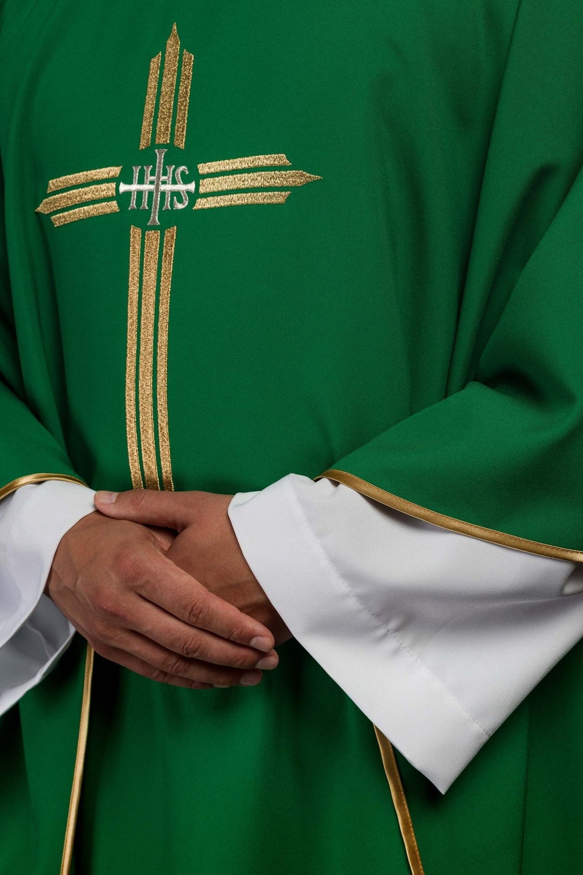 Green chasuble side close-up with gold cross embroidery and trim