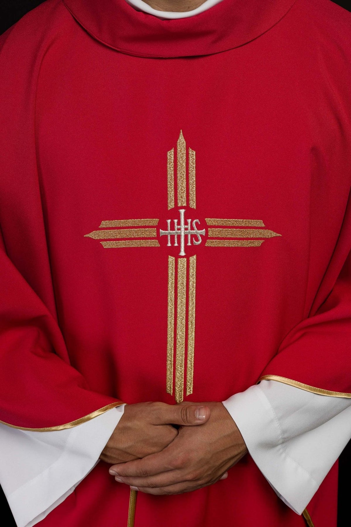 Red chasuble front close-up showing gold IHS cross embroidery