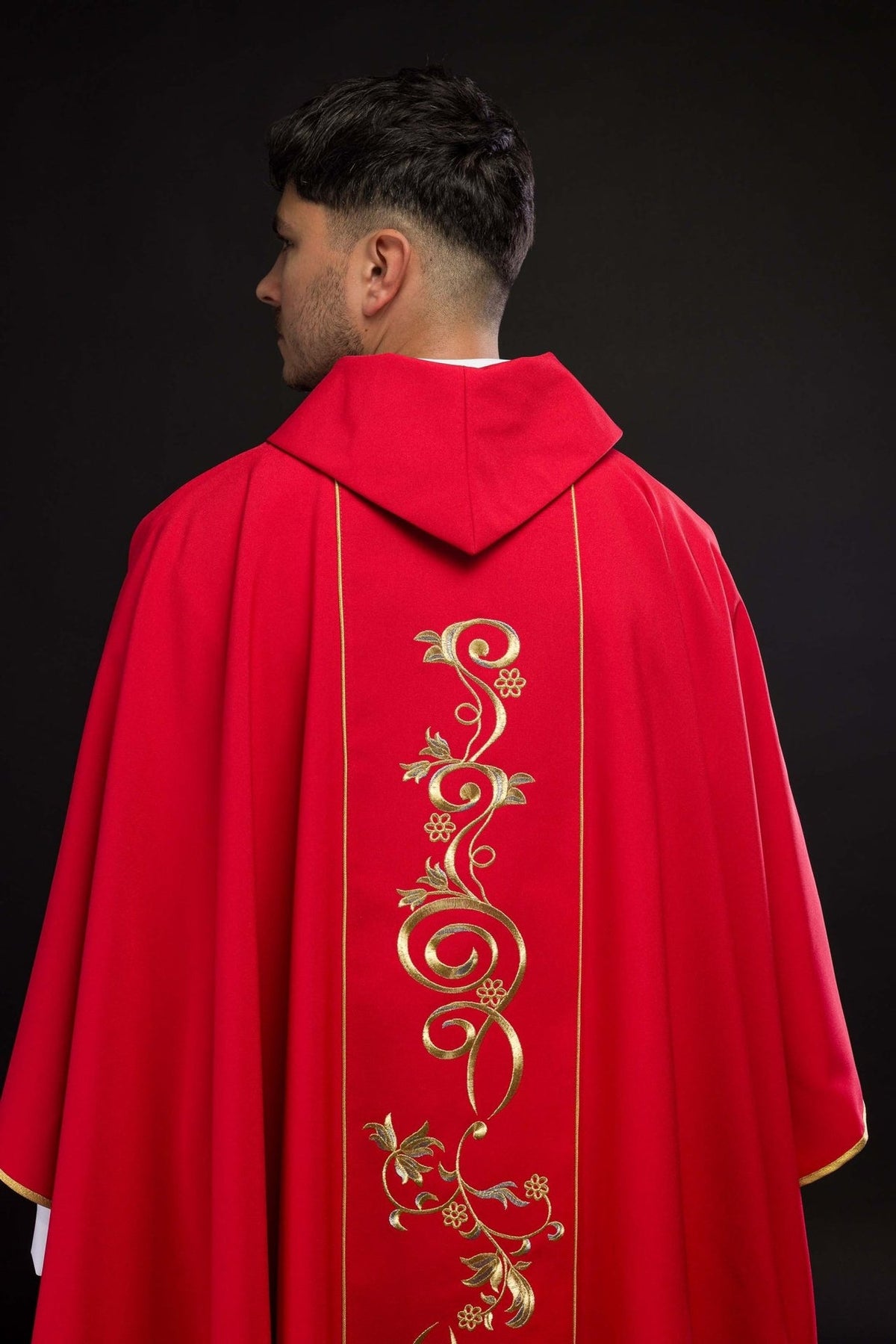 Fabric label and stitching detail belonging to the Red Embroidered Chasuble with IHS