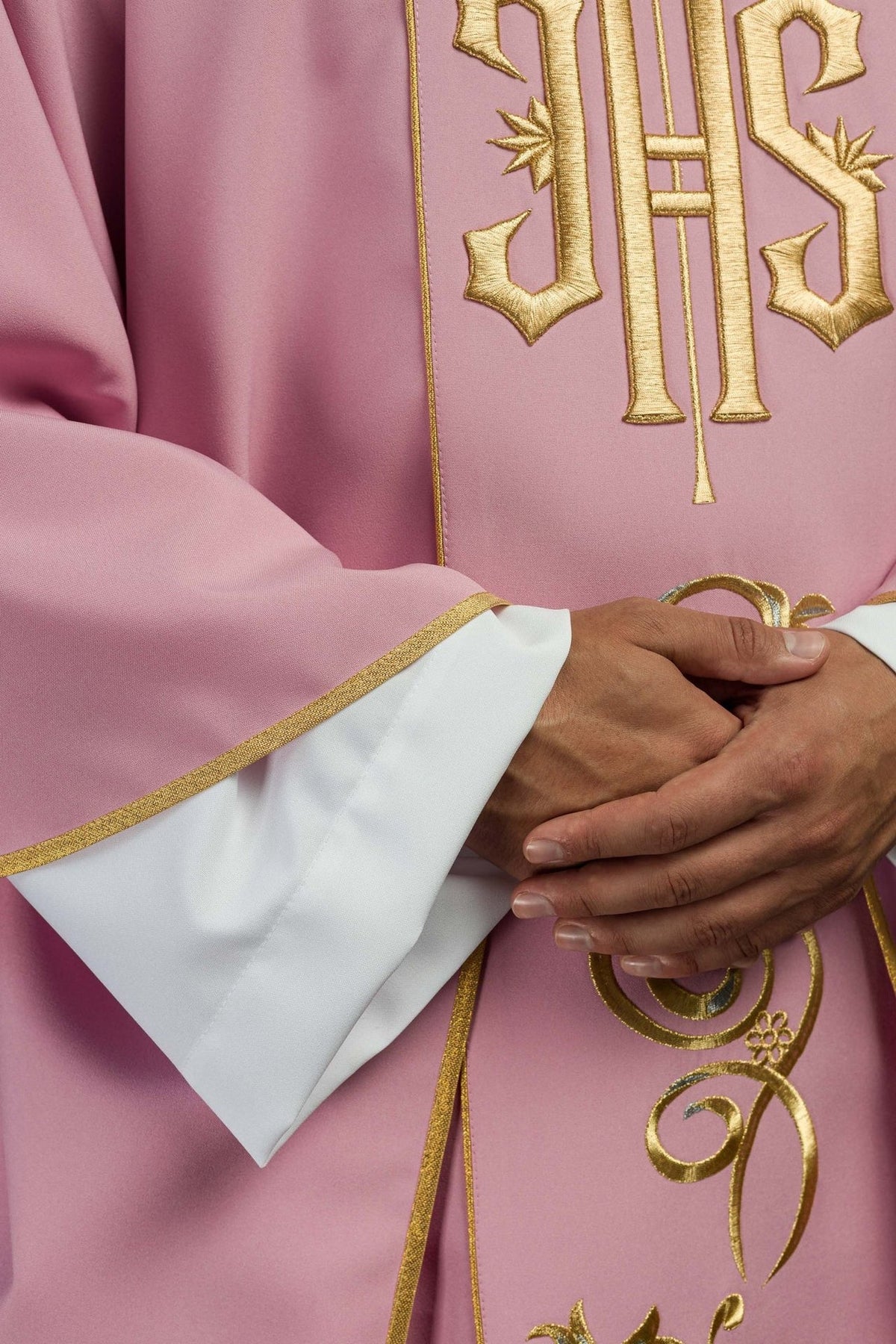Rose chasuble close-up showing gold trim, sleeve and floral embroidery