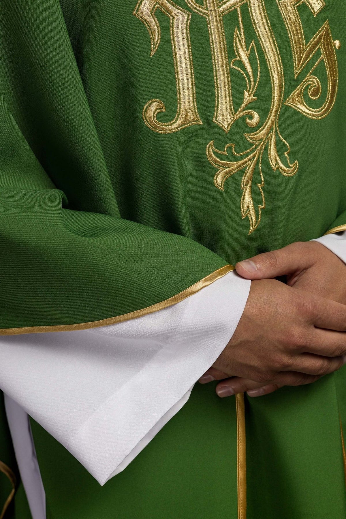 Green chasuble close-up showing gold trim and fabric