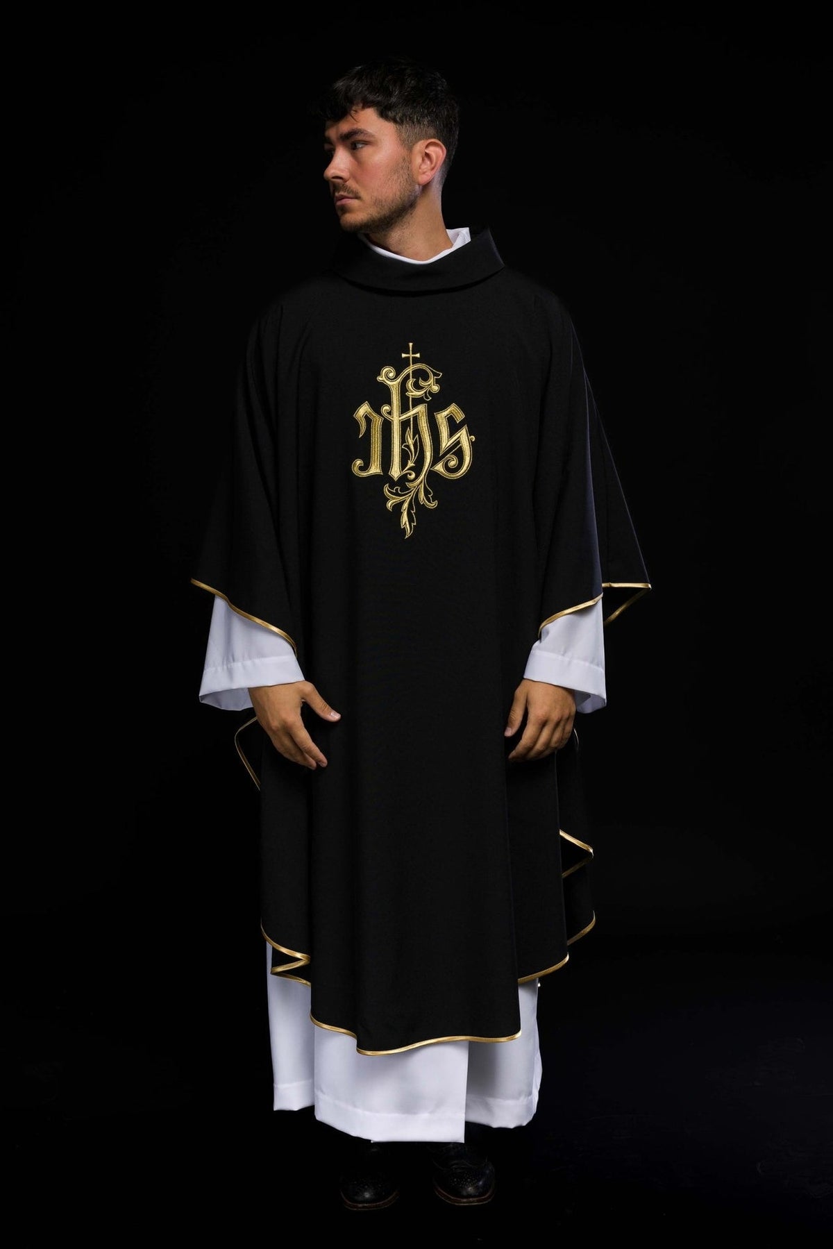 Black IHS chasuble worn full front view with gold trim