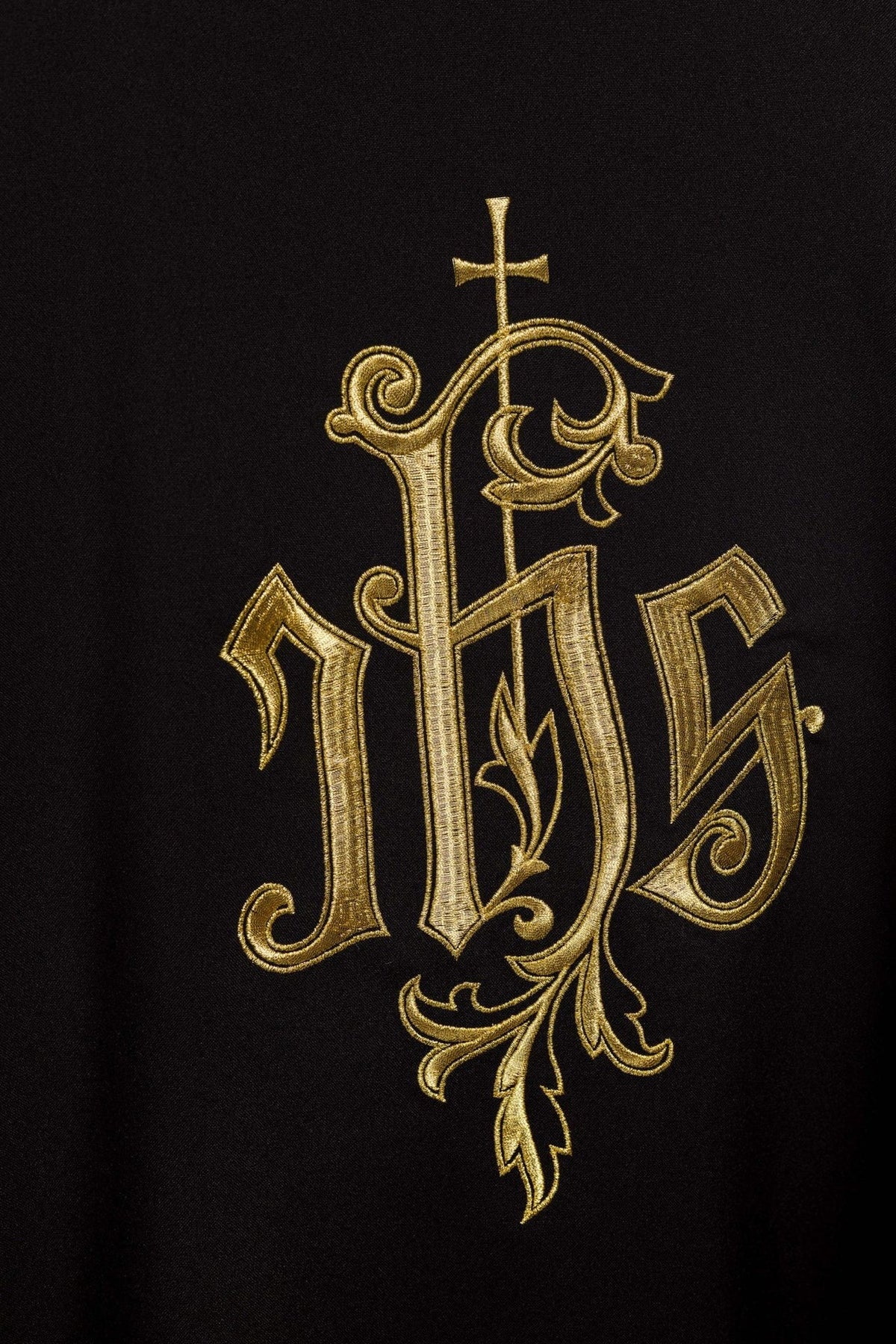 Black IHS chasuble close-up showing black fabric and gold trim